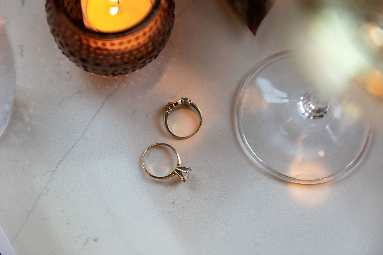 Candlelit wedding table setting with glowing amber votives and elegant wine glasses creating a romantic ambiance.