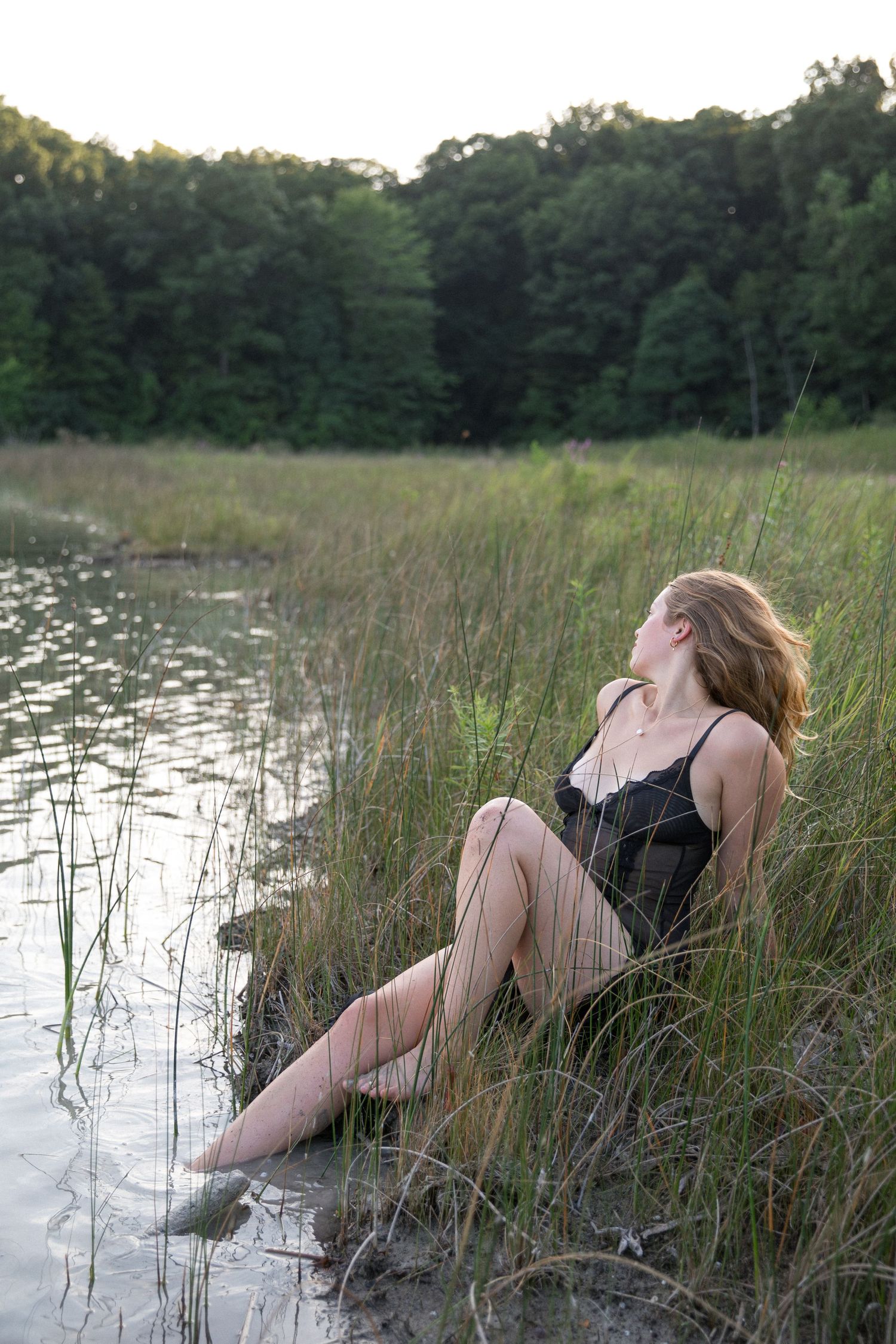 Artistic sequence of a figure reclining by a lake with tall grass at sunset.
