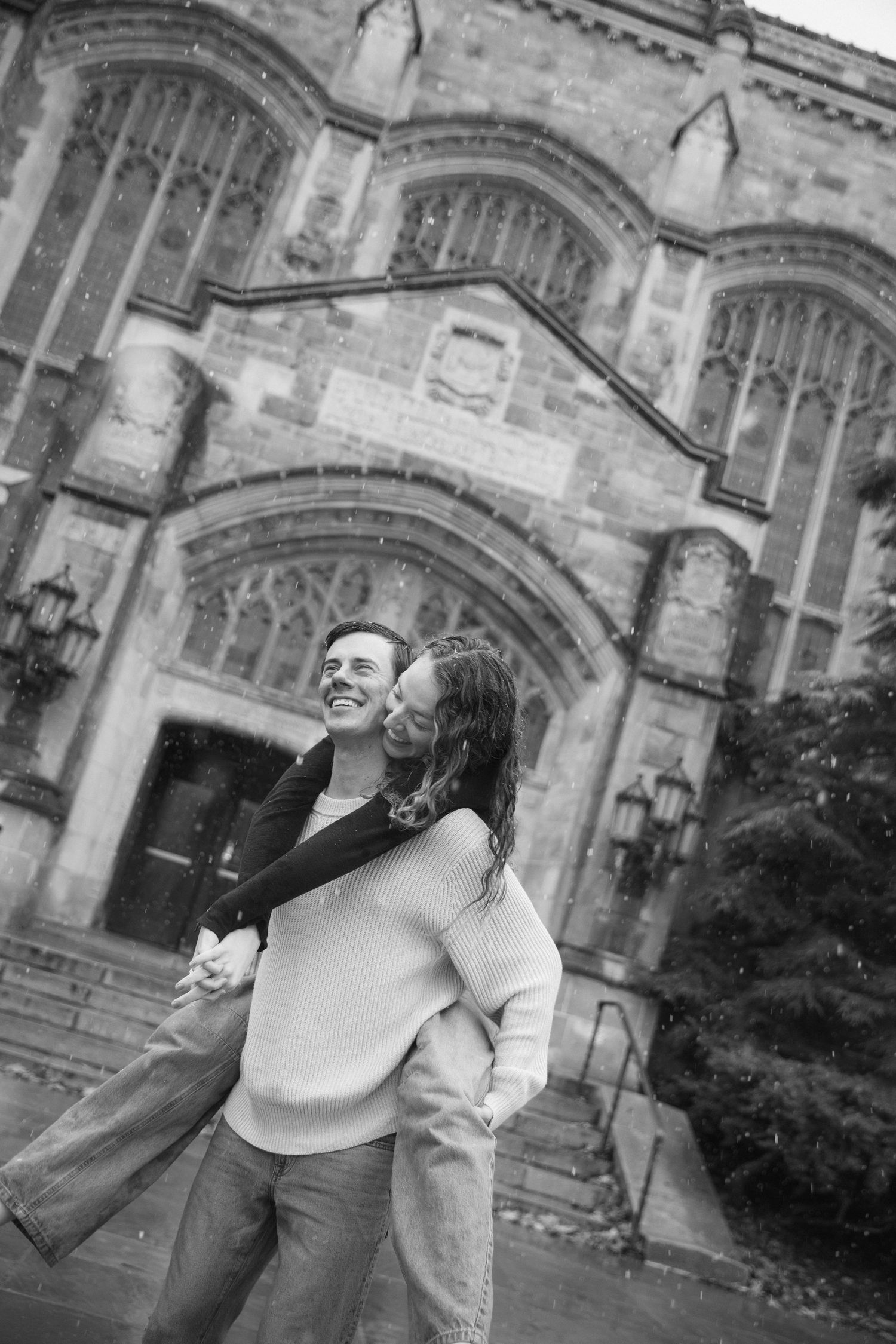 A romantic black and white photo sequence showing a couple embracing and kissing in front of a gothic stone building.