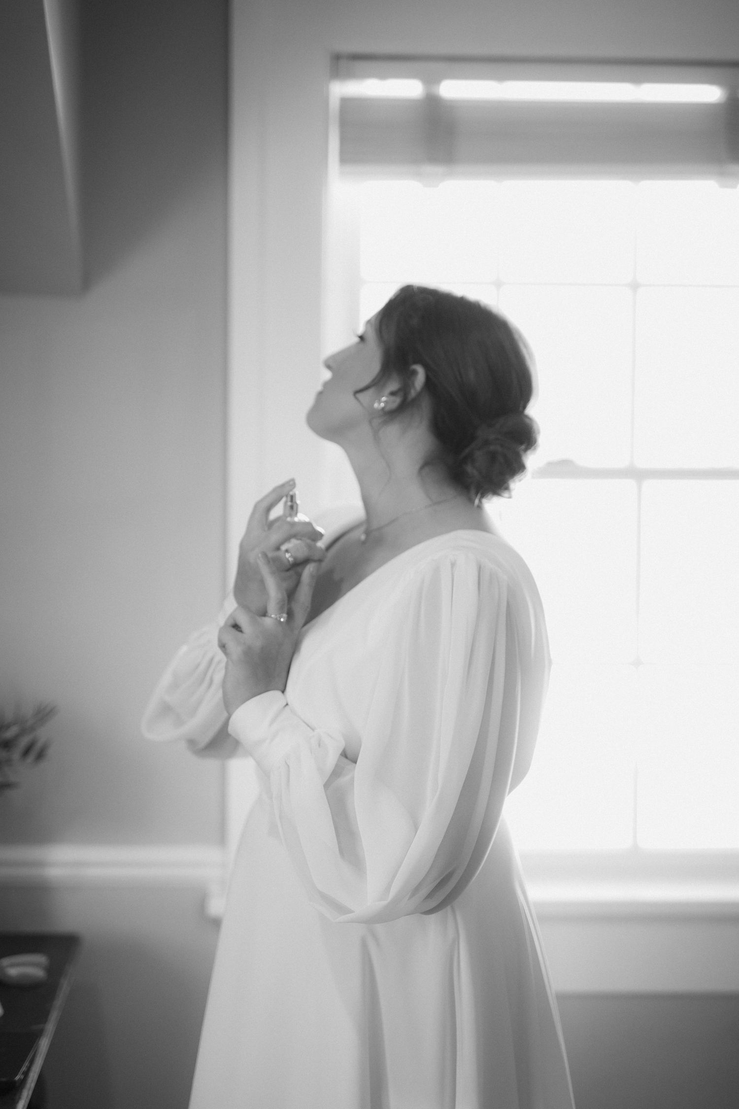 A series of black and white photos showing a person in white clothing against a bright window.