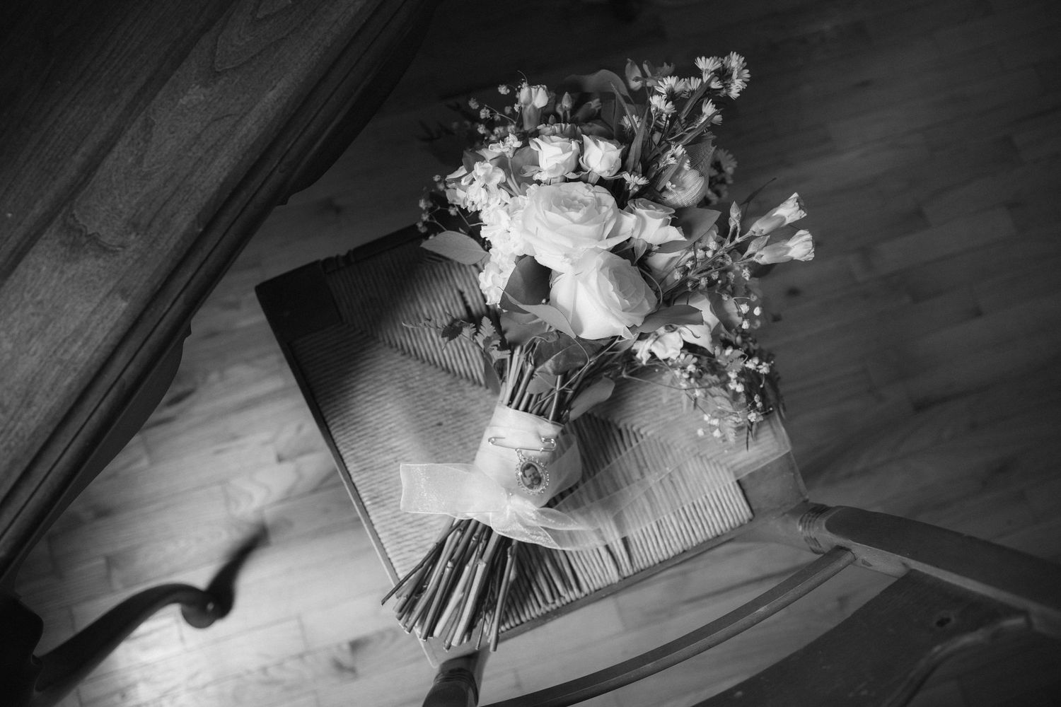 A collection of black and white photographs arranged in a row showing various personal items and documents.