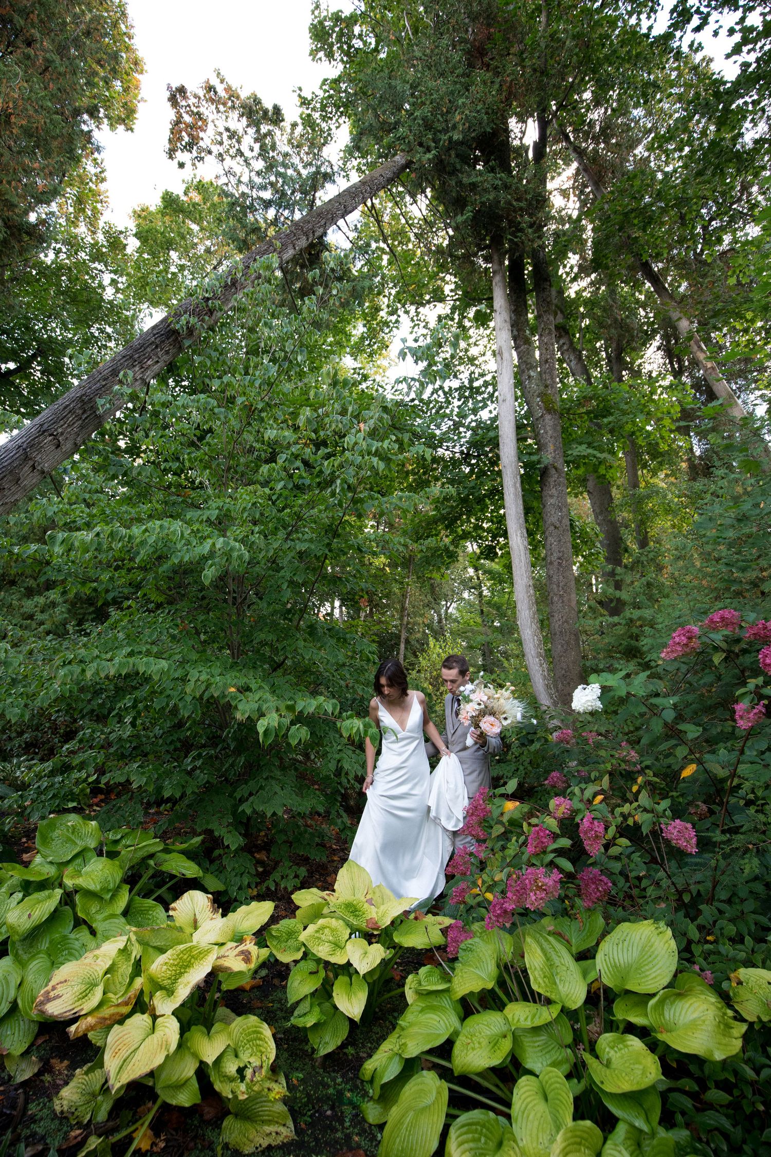 A sequence of images showing someone swinging on a rope in a lush garden setting with pink flowers and green foliage.