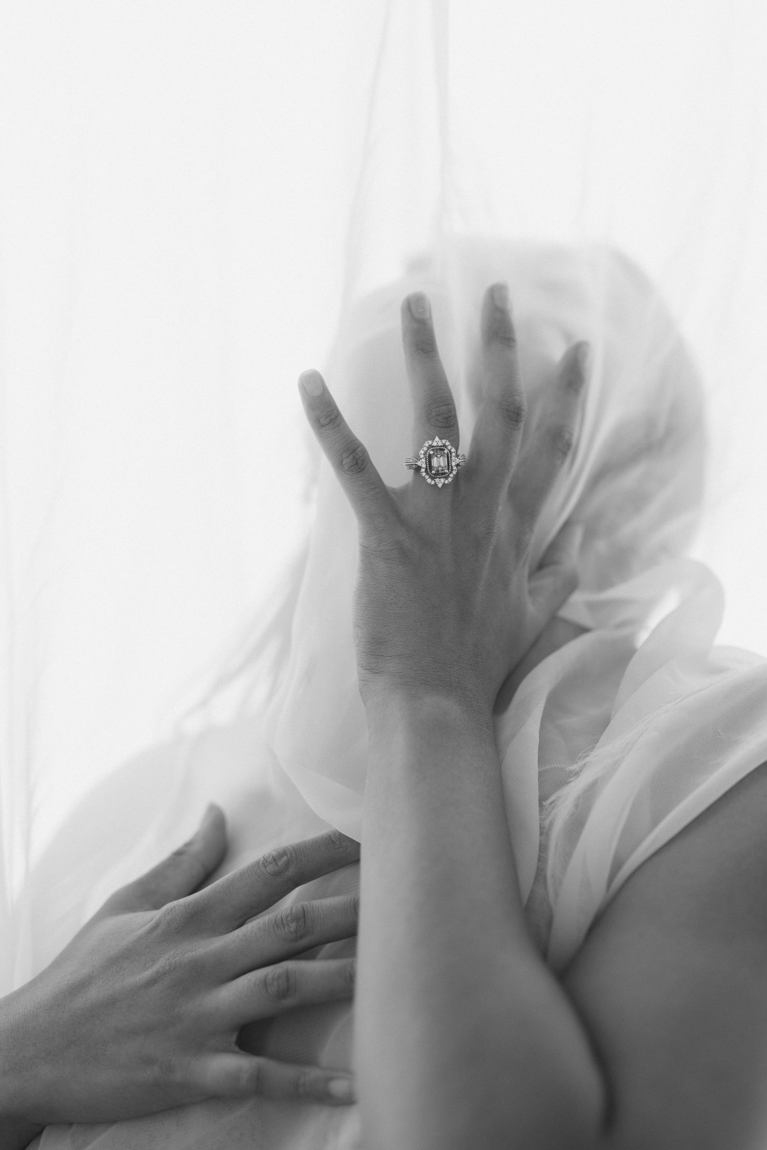 A black and white artistic photo series showing hands pressing against a sheer white fabric in different positions.