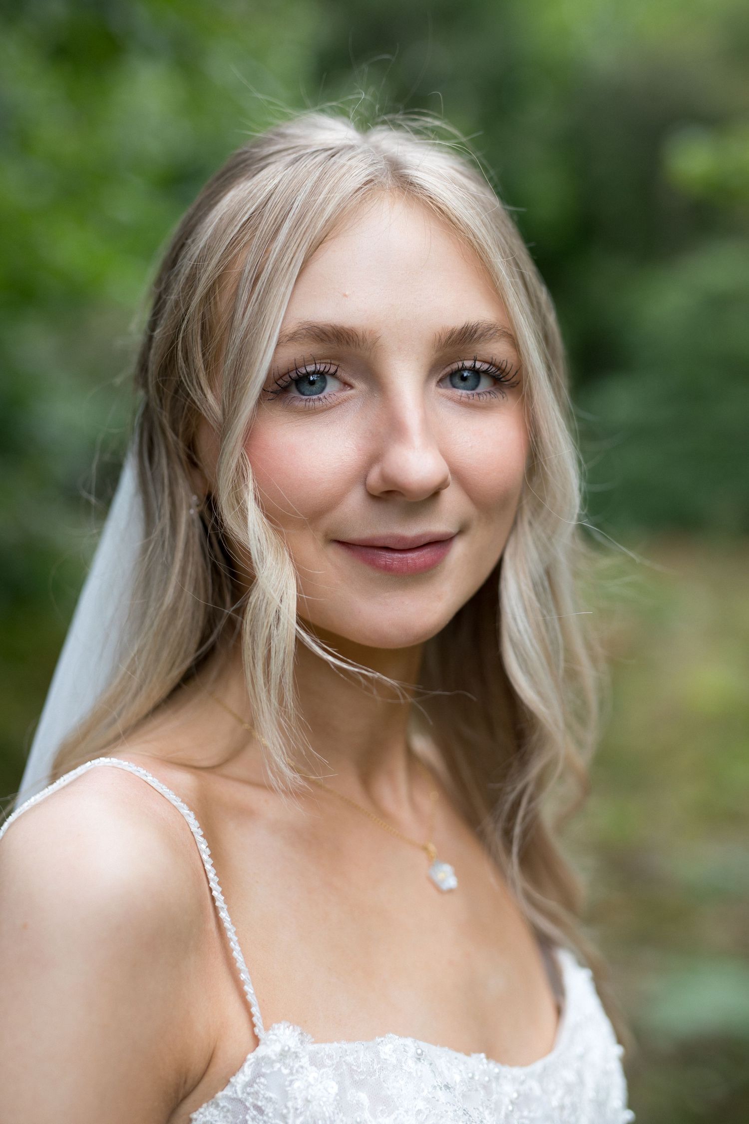 A series of close-up portraits showing a person with blonde hair wearing a white dress in an outdoor garden setting.