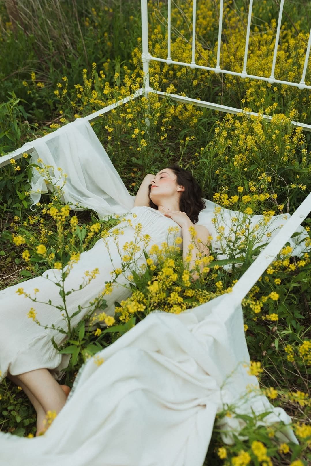 A dreamy artistic photo series showing a figure in white dress lying among blooming yellow wildflowers in a meadow.