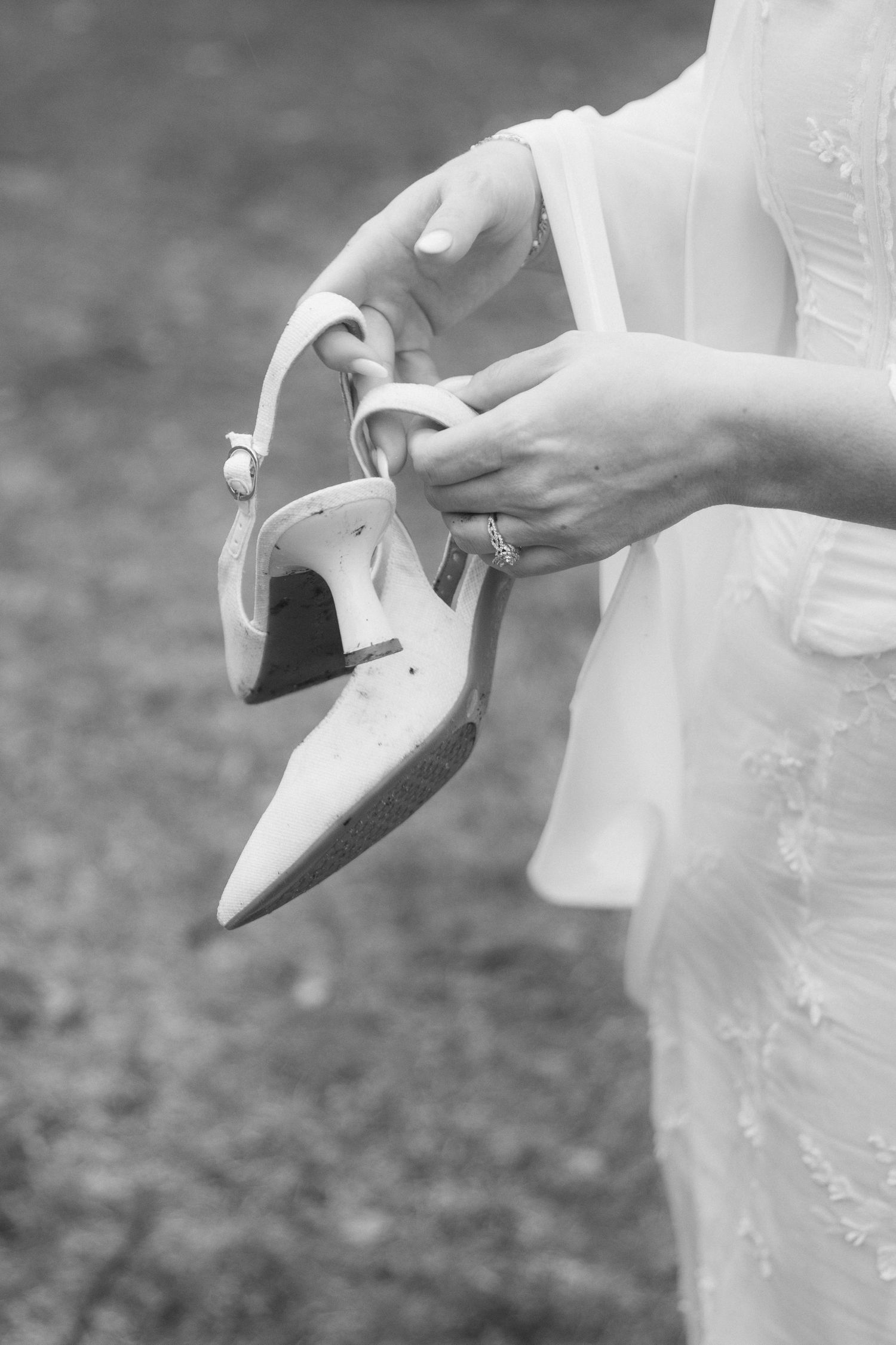 A close-up black and white photo sequence showing hands putting on white bridal shoes or heels.