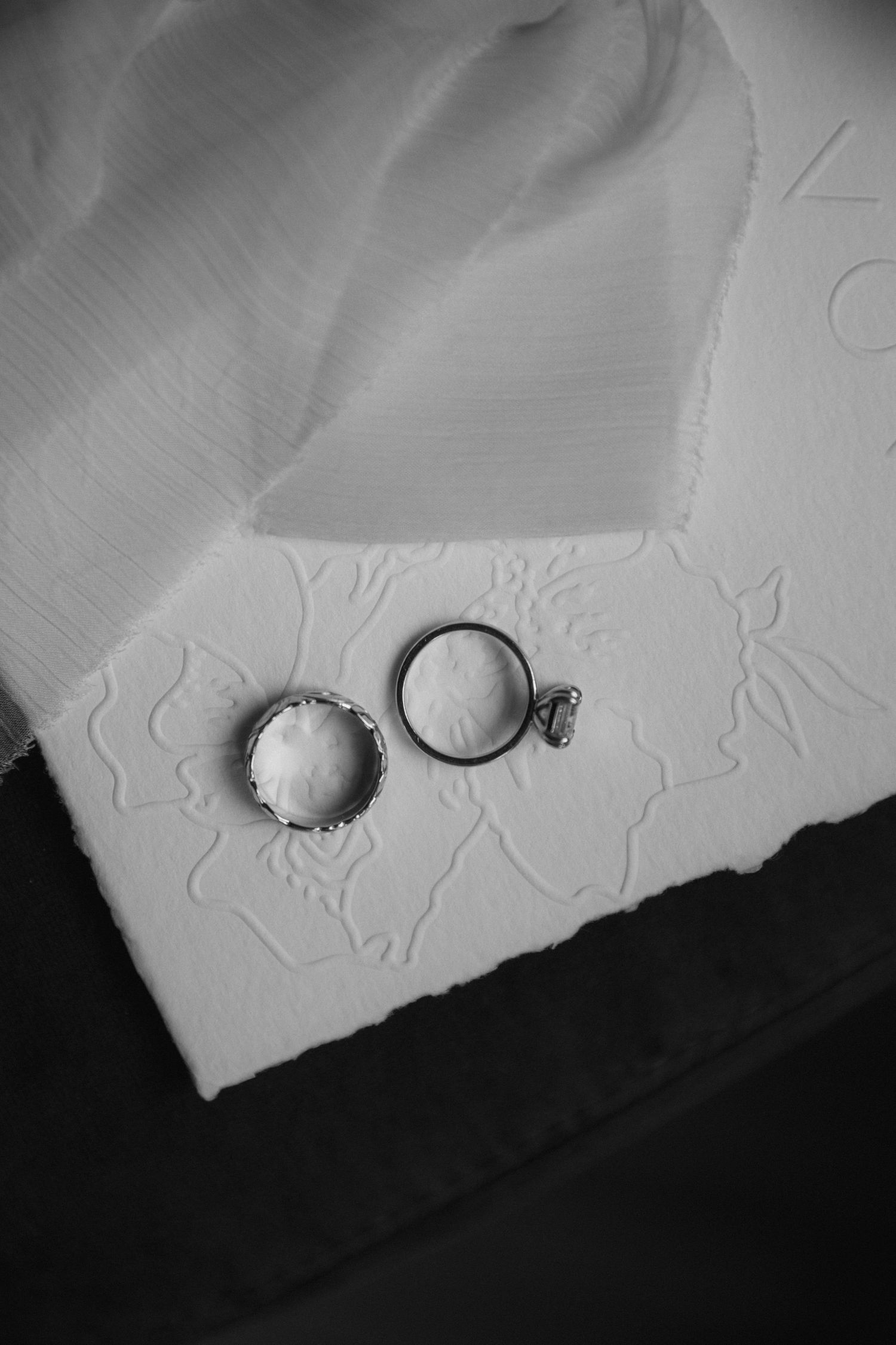 A series of black and white close-up photographs showing embossed or textured patterns on a light-colored surface.
