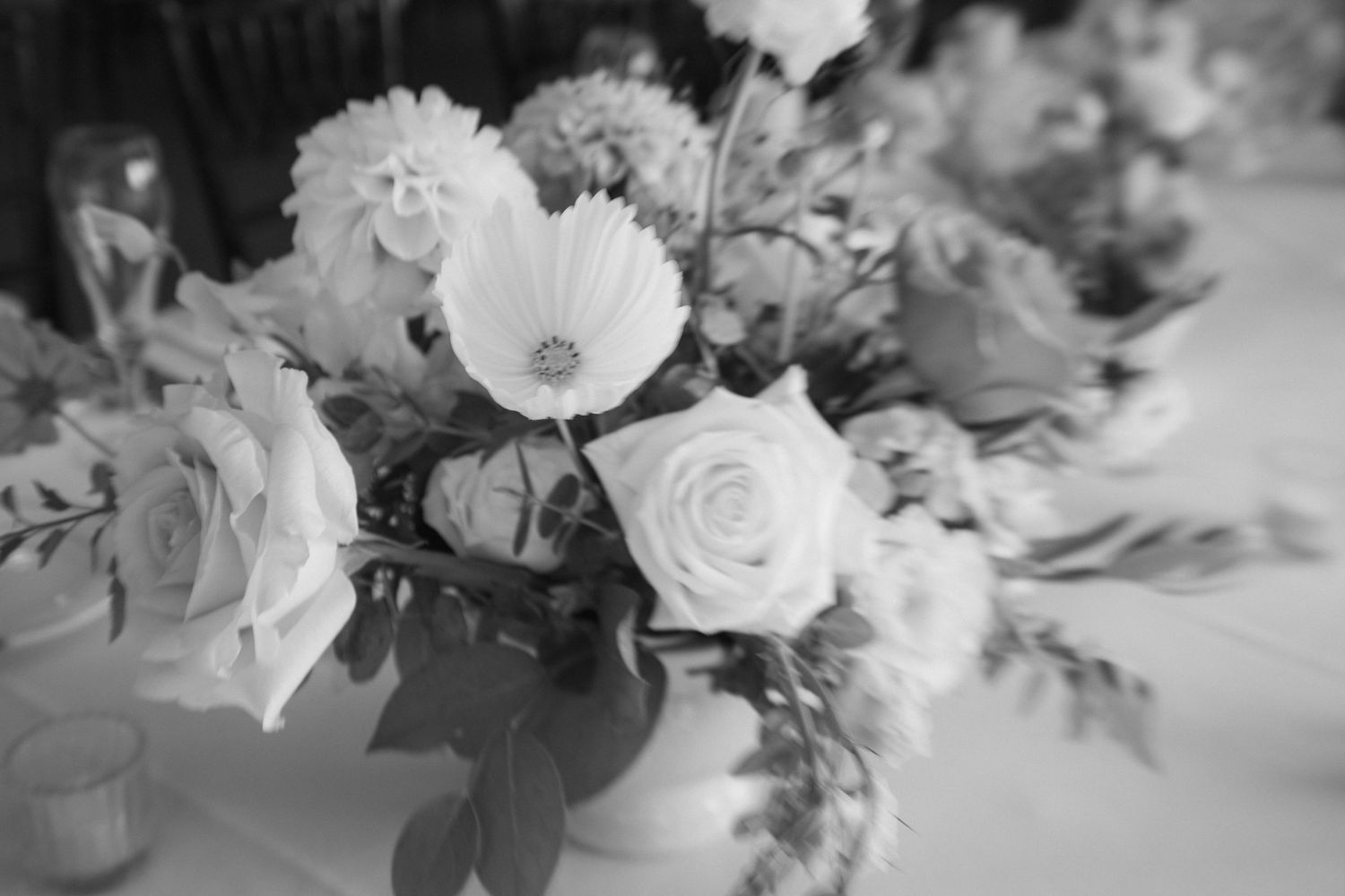 A black and white collage of floral arrangements featuring roses, peonies and mixed flowers in various vases.