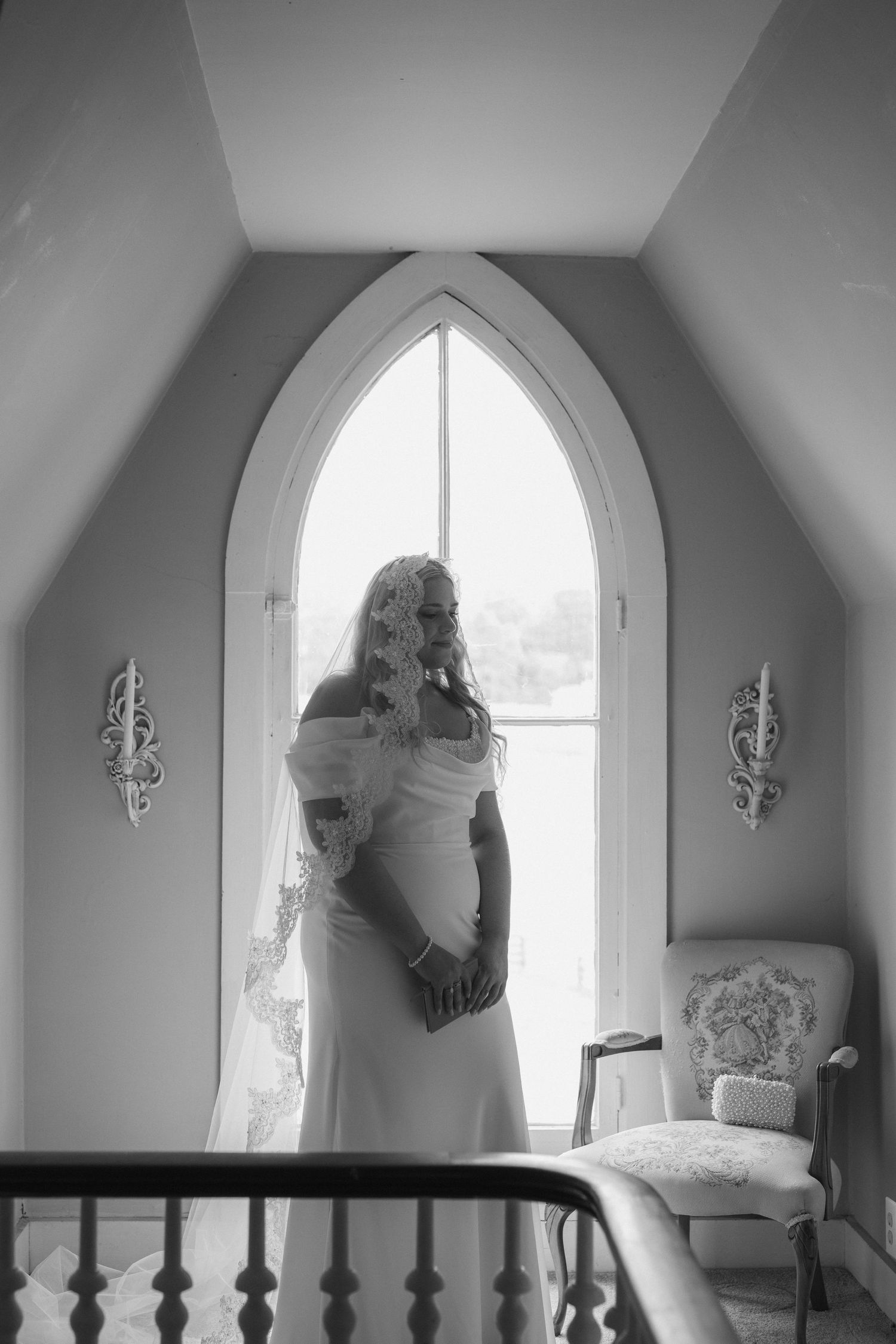 A sequence of black and white photos showing a figure in a flowing white dress by an arched window.