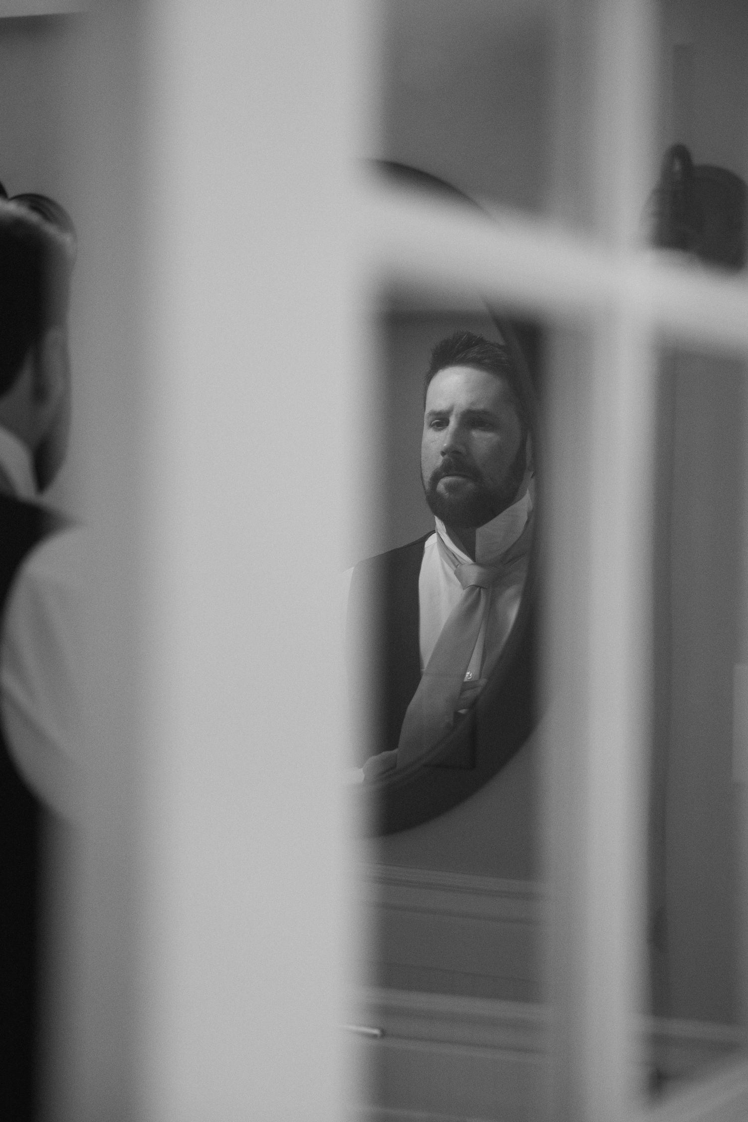 A black and white photo sequence showing a figure behind window panes creating a dramatic shadowy effect.