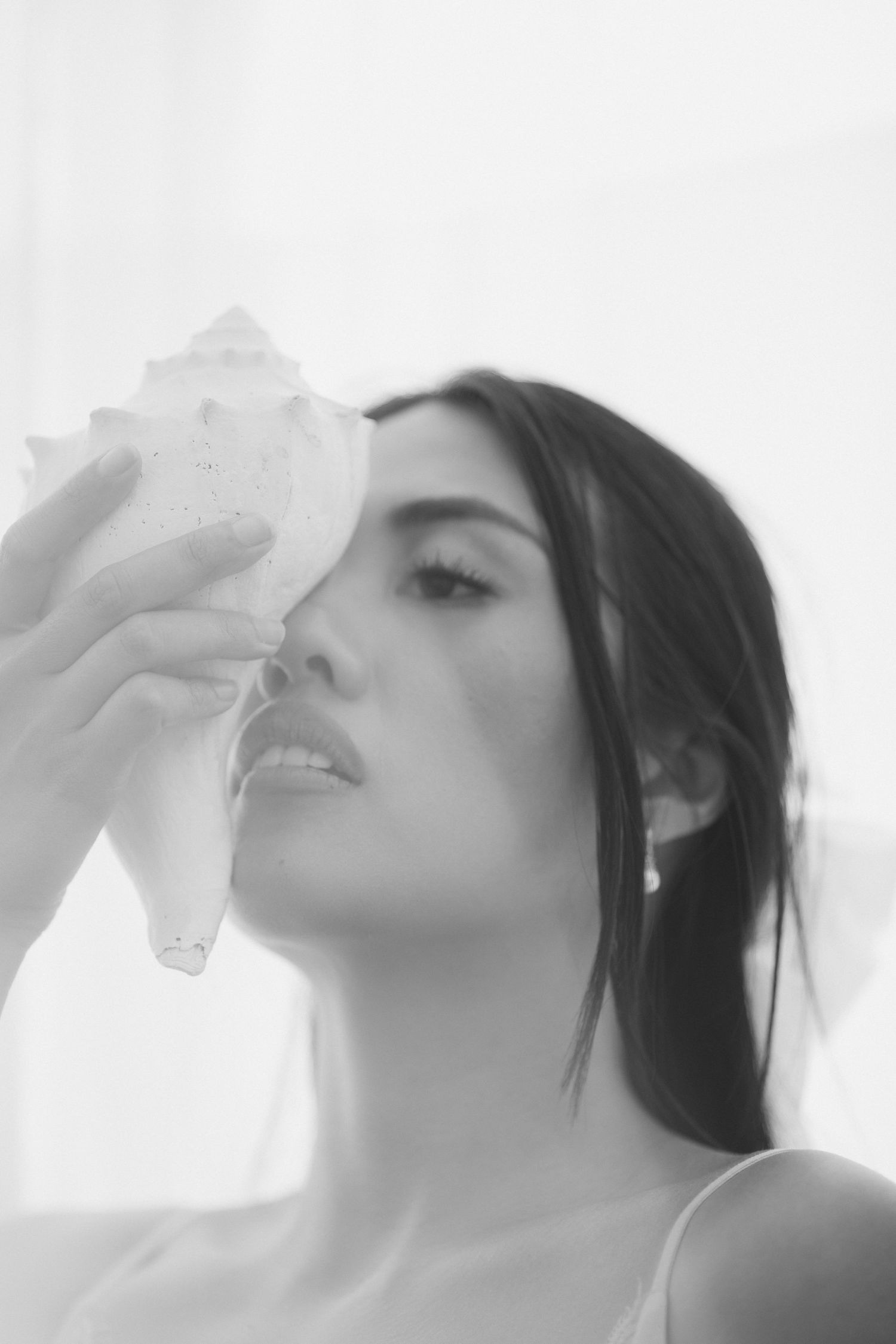 A series of black and white artistic profile shots showing someone drinking water against a light background.