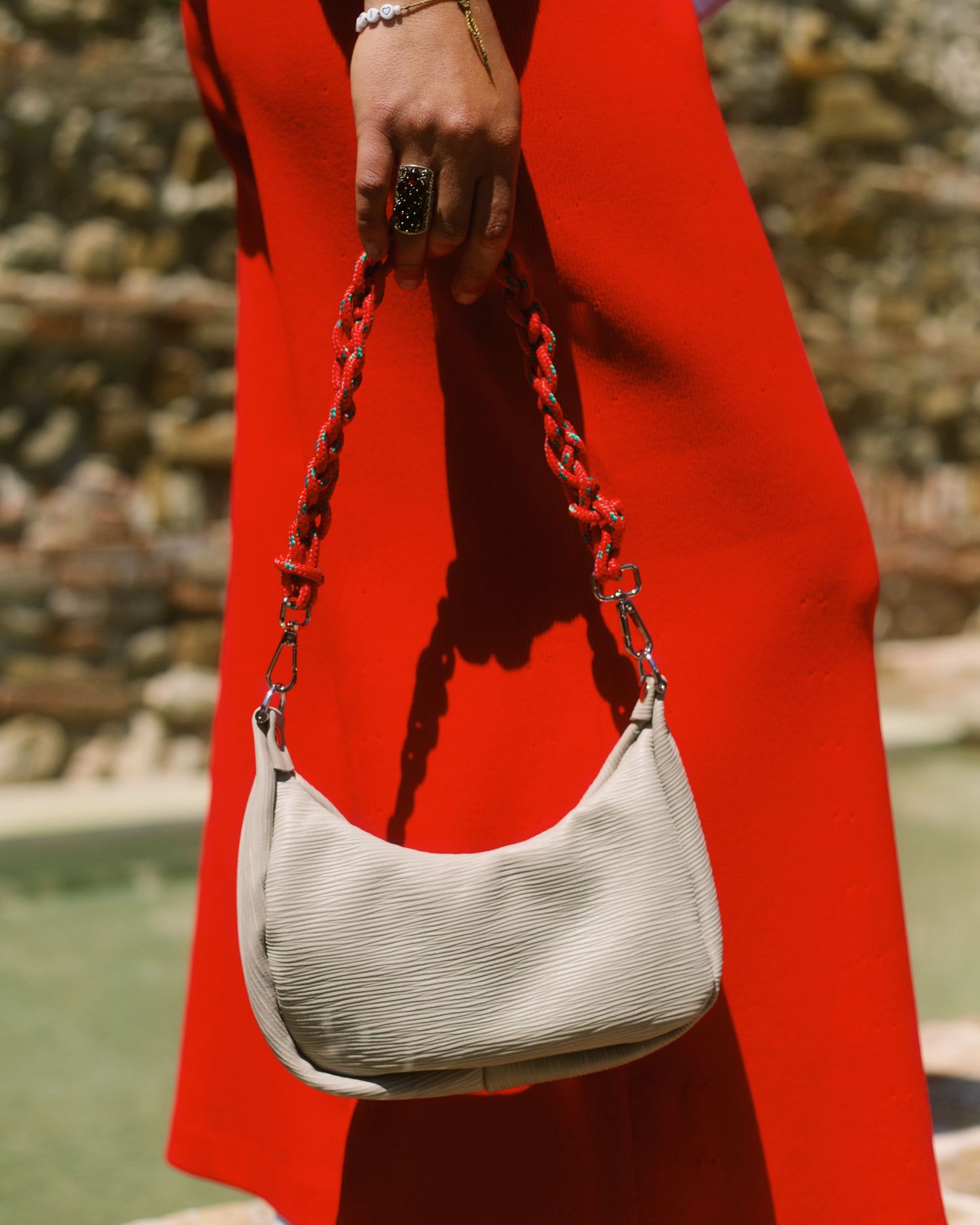Photograph of a bag detail on red pants. Photography by studio sale.