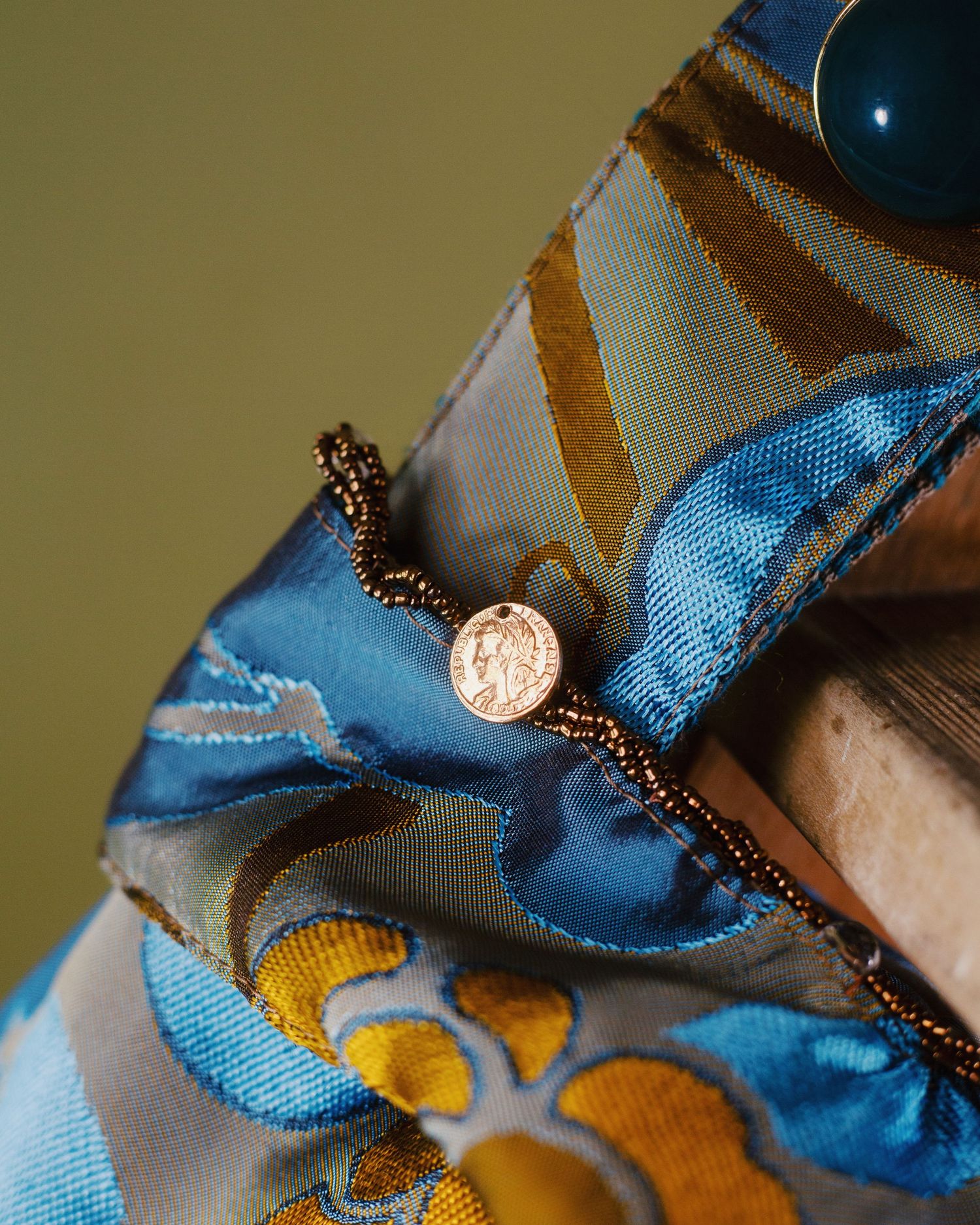 Studio still life photographs of DALì handbags, shot against a colored background.