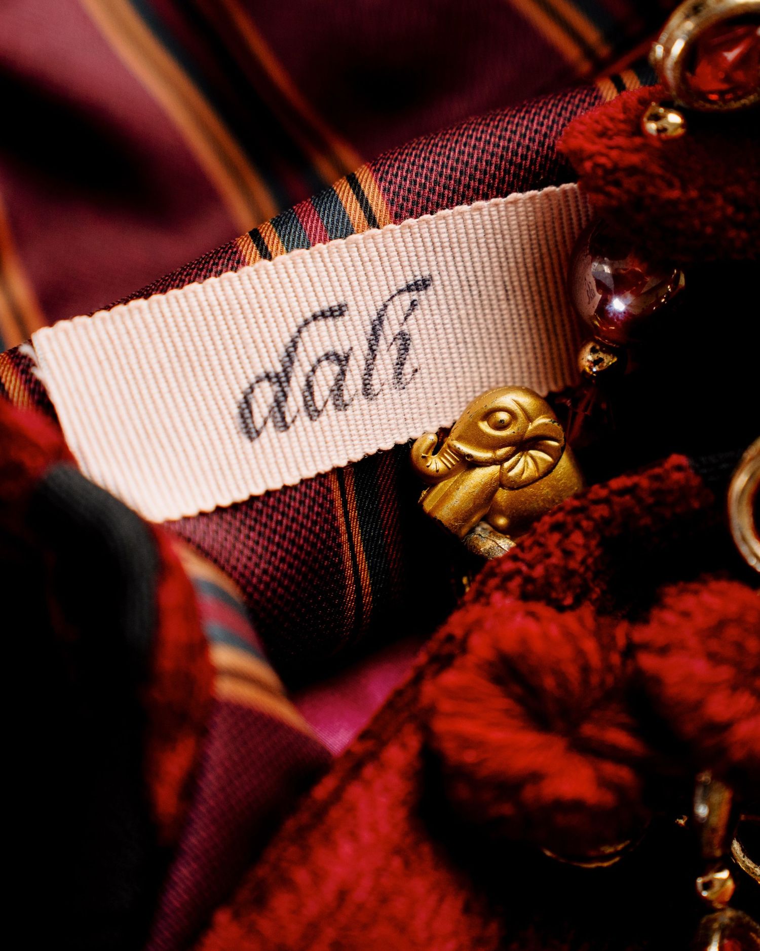 Studio still life photographs of DALì handbags, shot against a colored background.