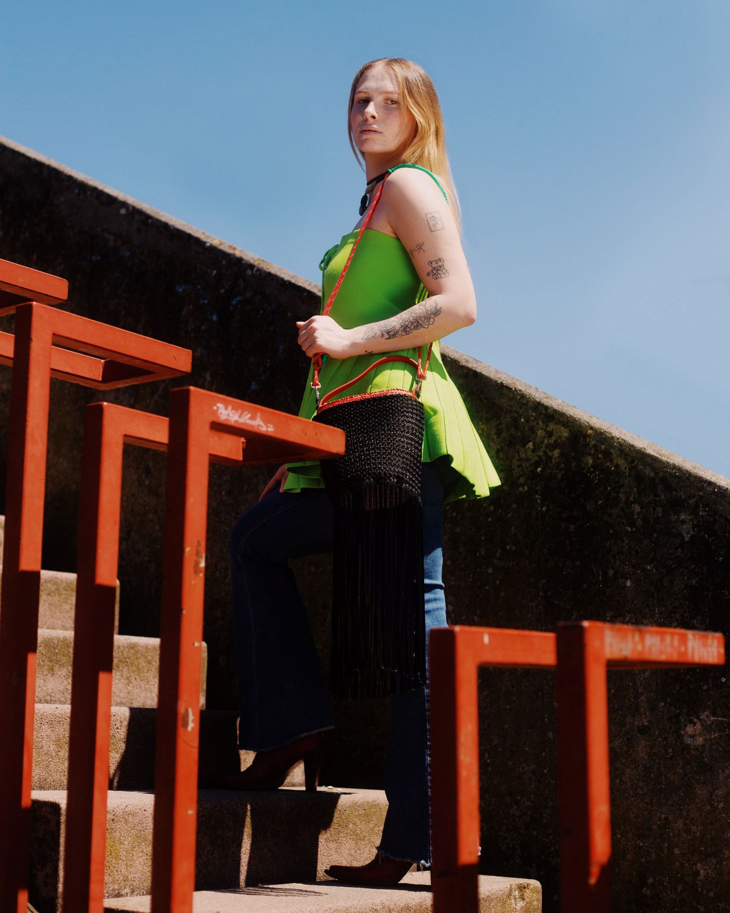 Photograph of a blond girl wearing a green shirt. Photography by studio sale.
