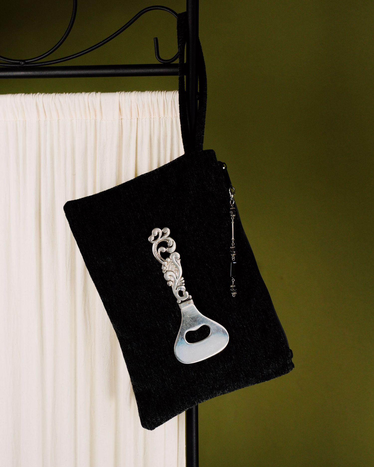 Studio still life photographs of DALì handbags, shot against a colored background.