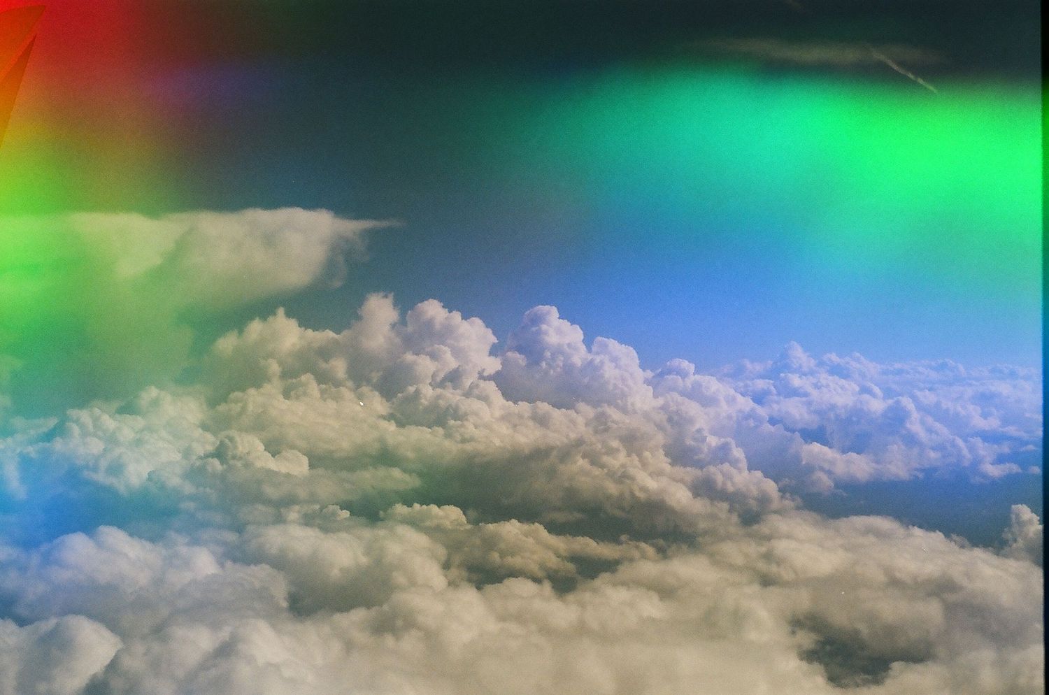 Rainbow lens flare image of clouds