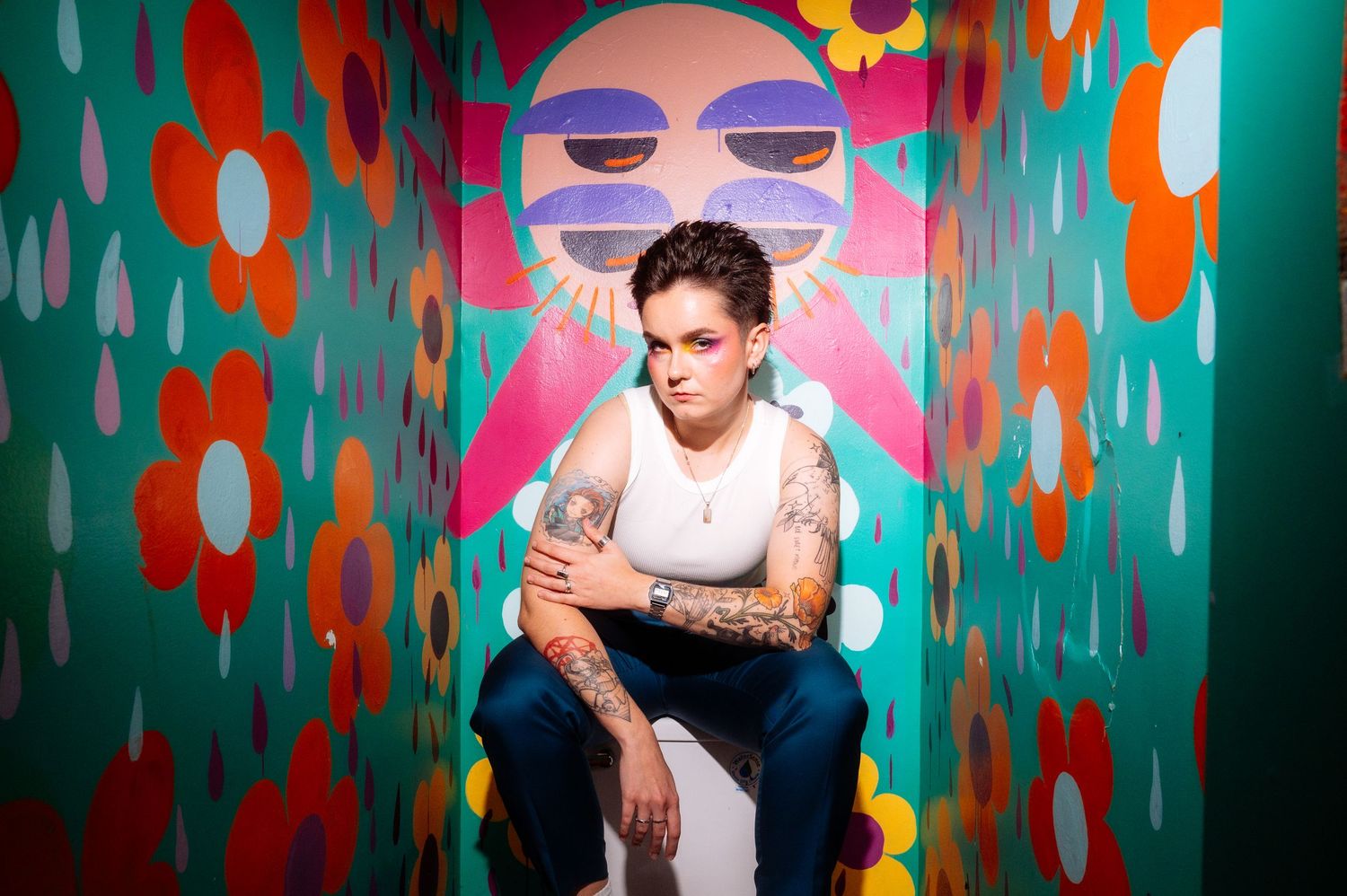 Tattooed groom poses for artistic and fun wedding reception photos