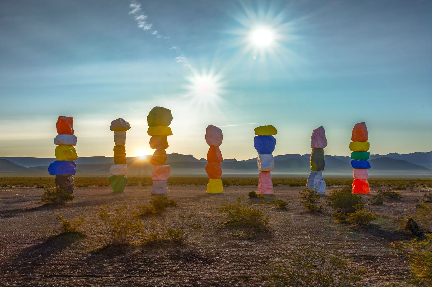 Seven Magic Mountains colorful stacked boulder art installation in Nevada desert at sunrise