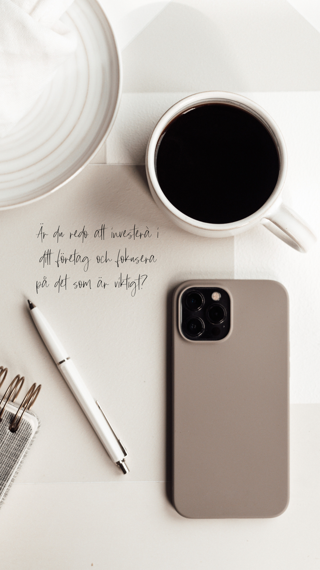 Flat lay of coffee cup, tan iPhone, pen and handwritten Swedish business note on white desk.
