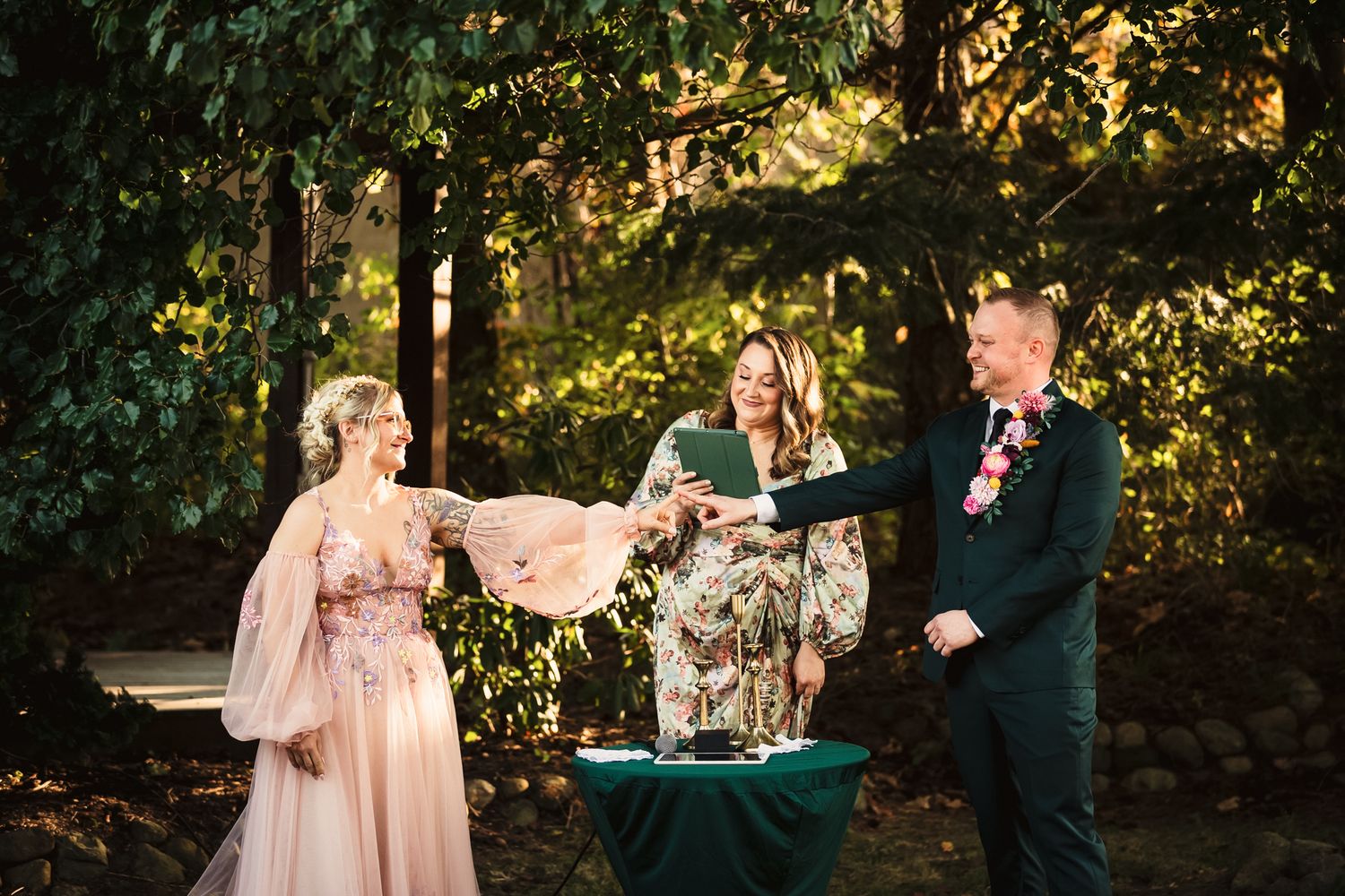 Wedding party walking through a sunlit garden path during golden hour.