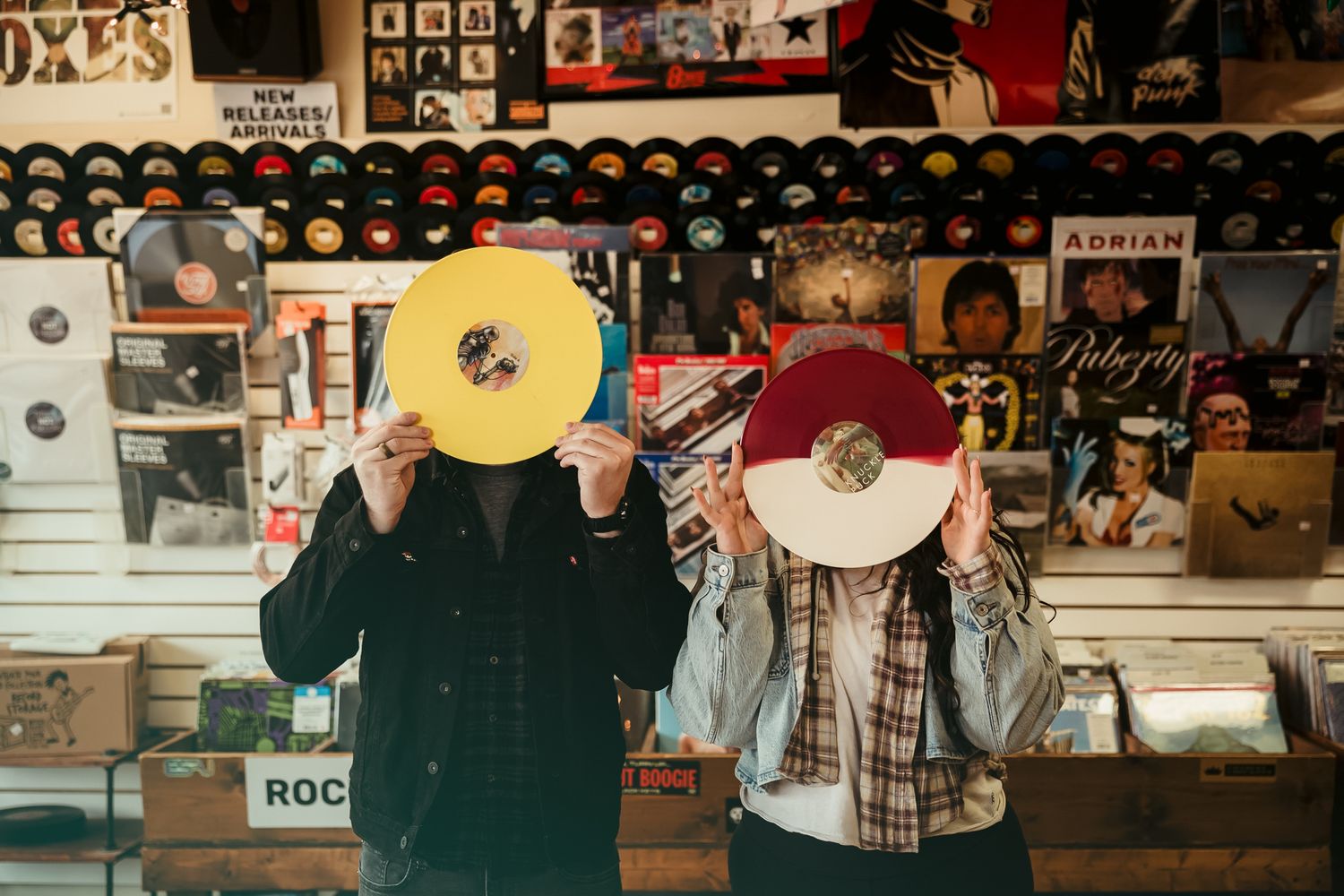 Record store interior with vinyl displays and music memorabilia on walls.