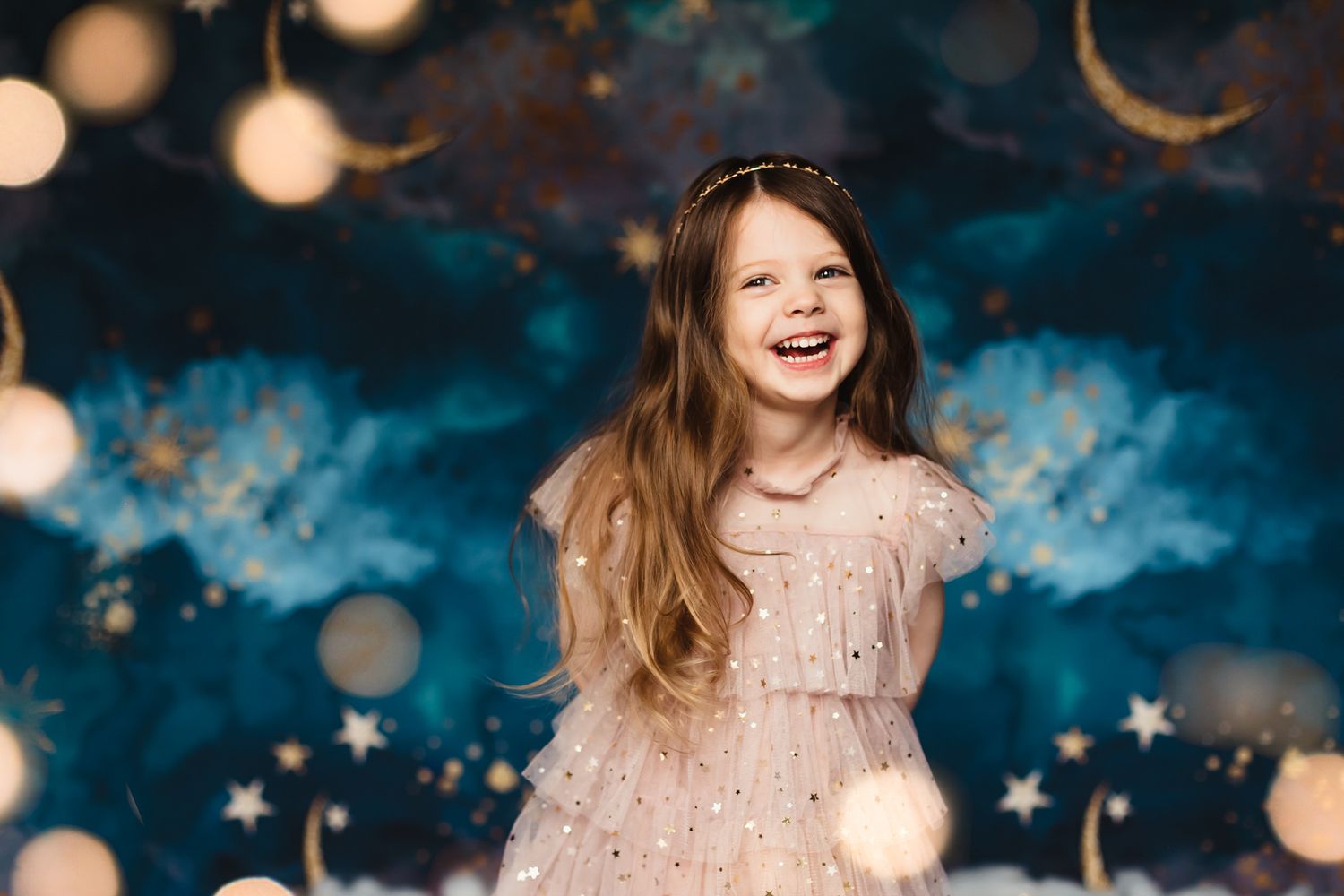Magical nighttime scene with bokeh lights and starry blue backdrop.