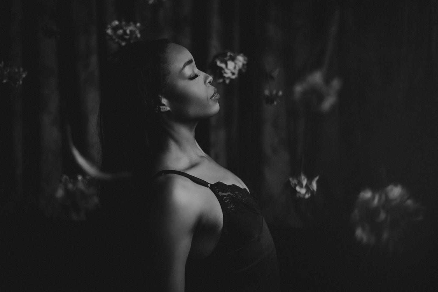 A series of black and white portraits showing a woman in different poses against a dark background.