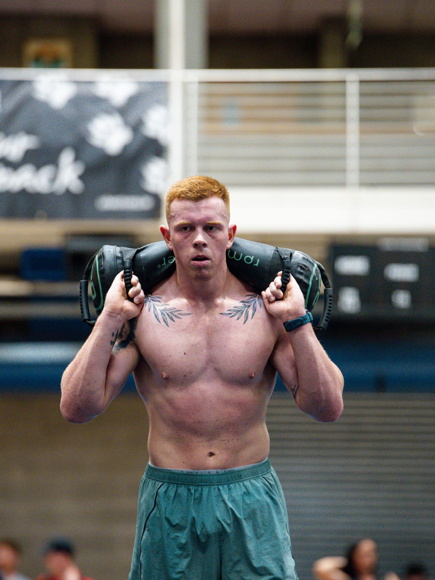 Athletic person holding kettlebells during workout session in gym setting.