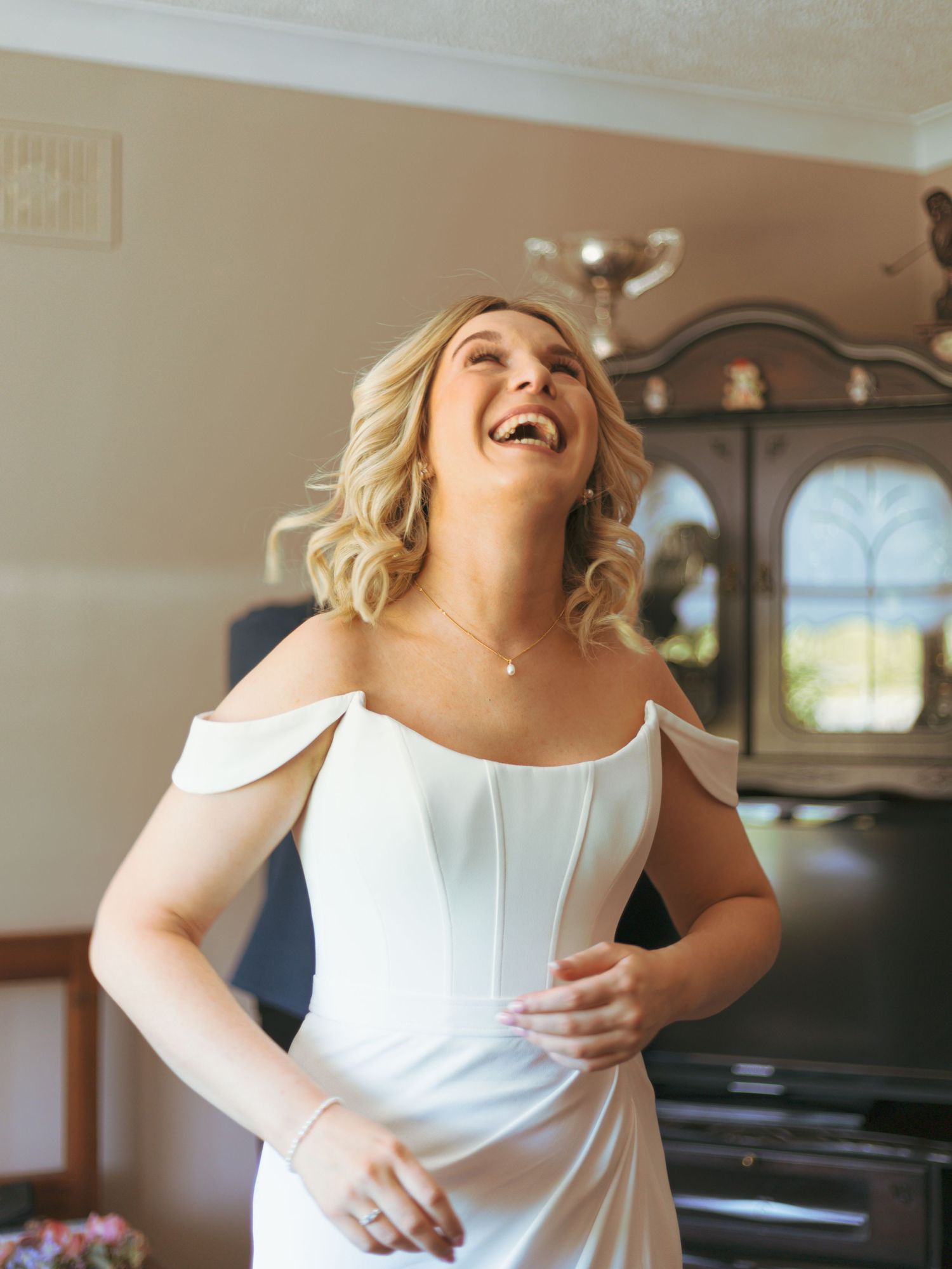 Close-up shots of a white formal dress with clean lines and structured bodice.