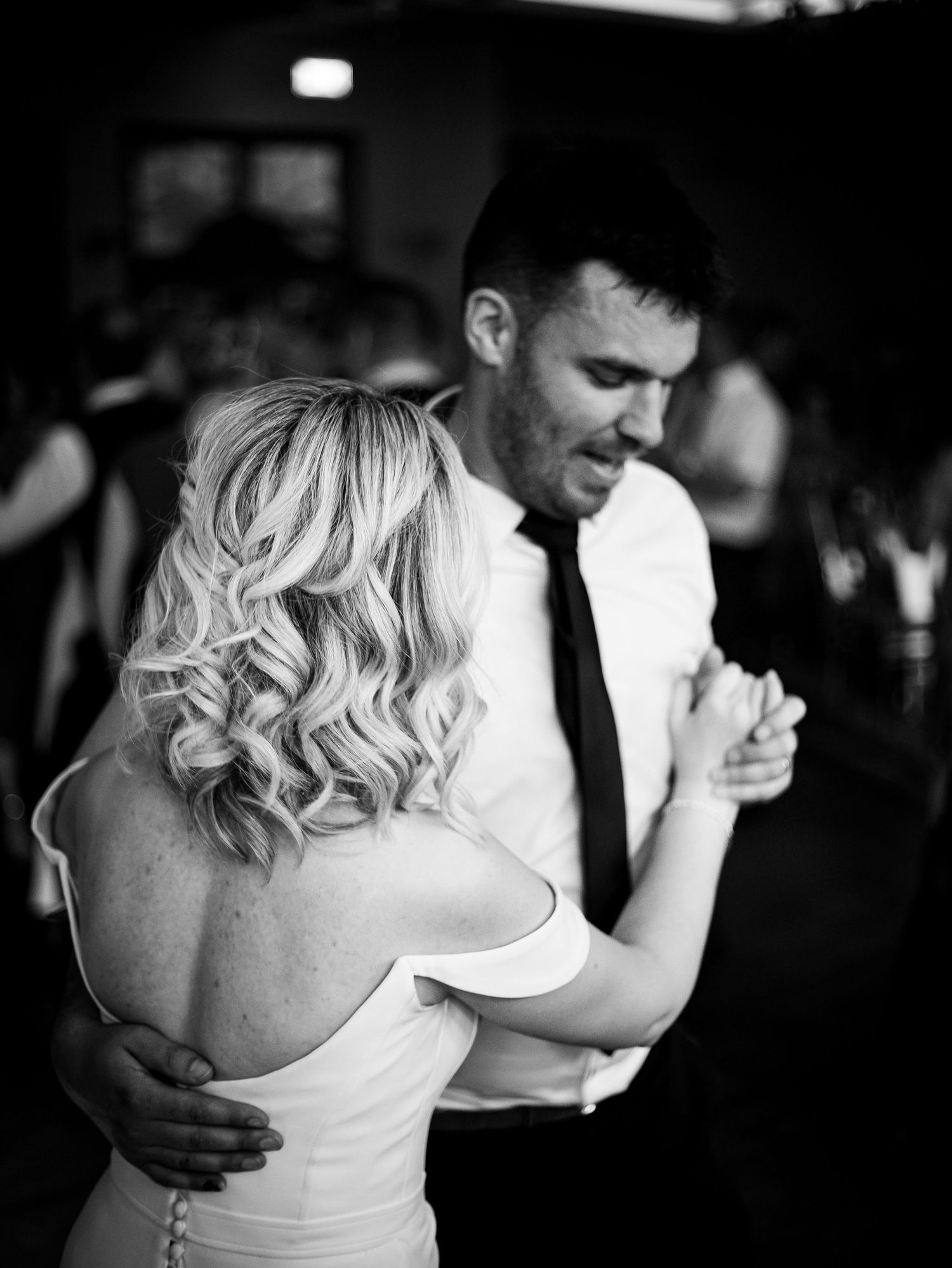 Intimate black and white dance floor moment at wedding reception.
