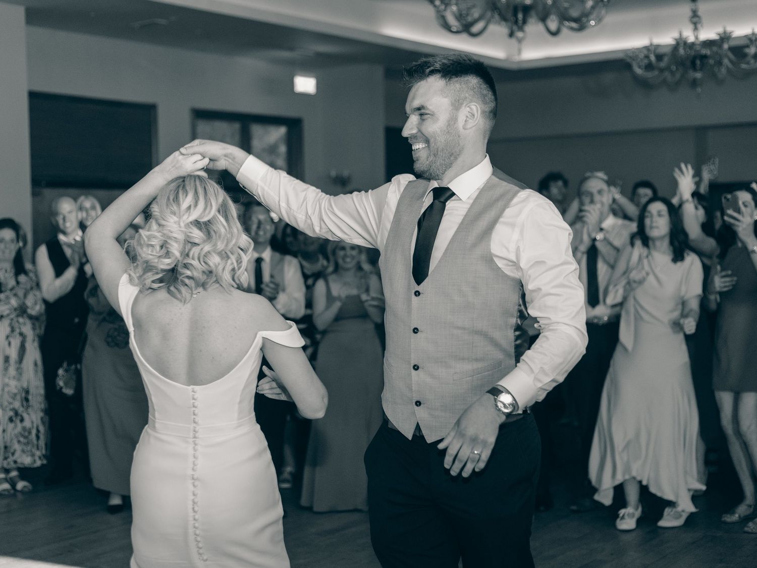 Wedding reception dance sequence showing graceful movements on a polished dance floor.