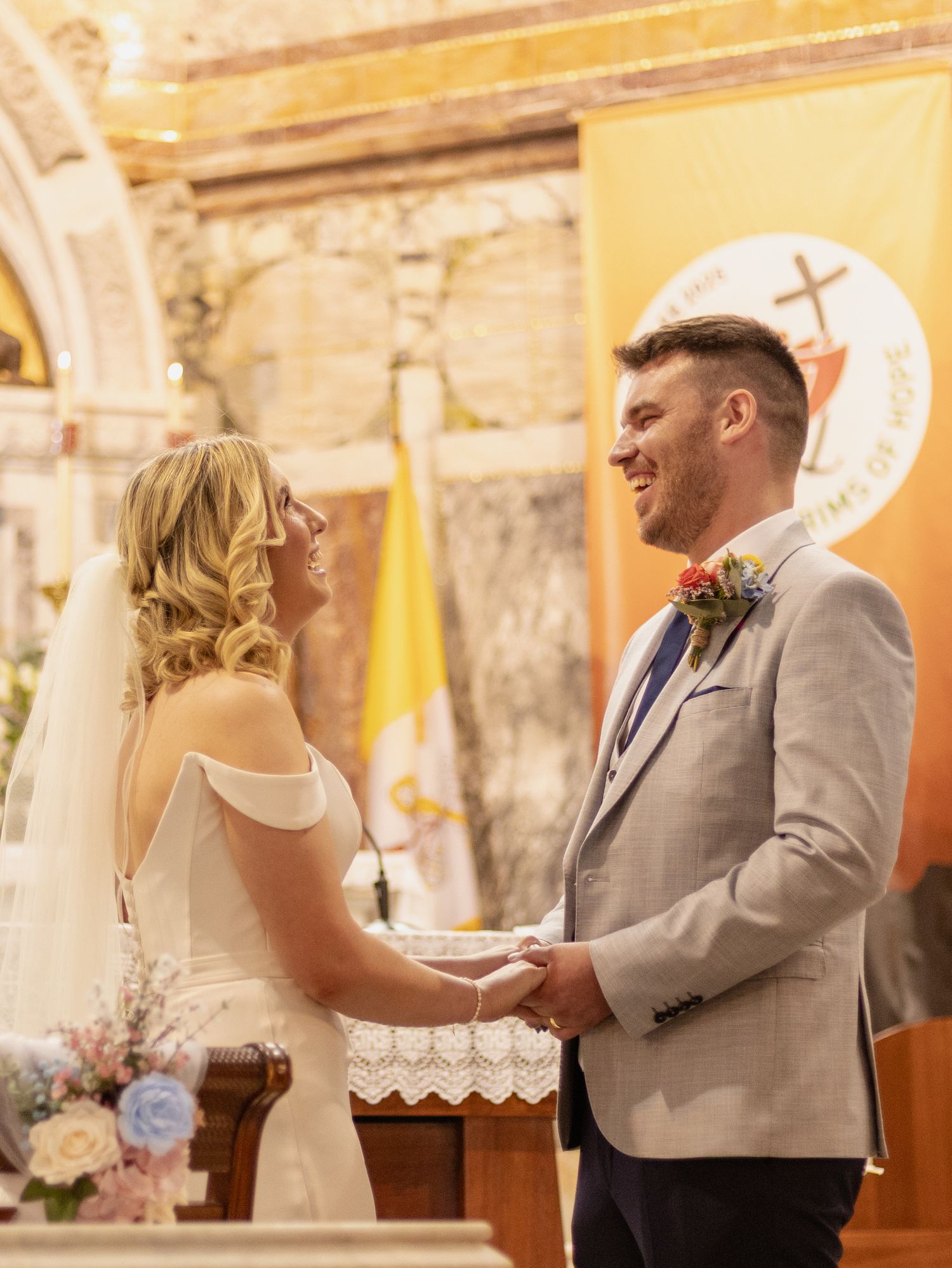 Bride and groom exchanging vows at church altar during wedding ceremony.