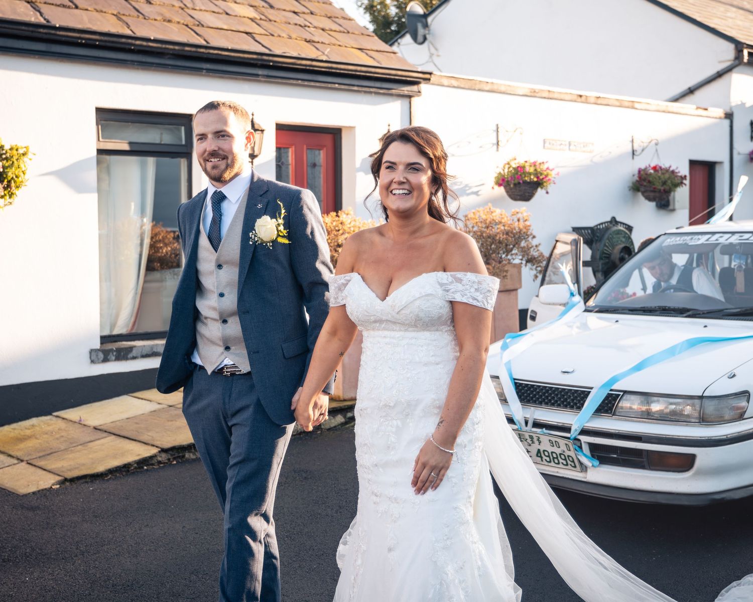 Newlyweds walking together outside after wedding ceremony.