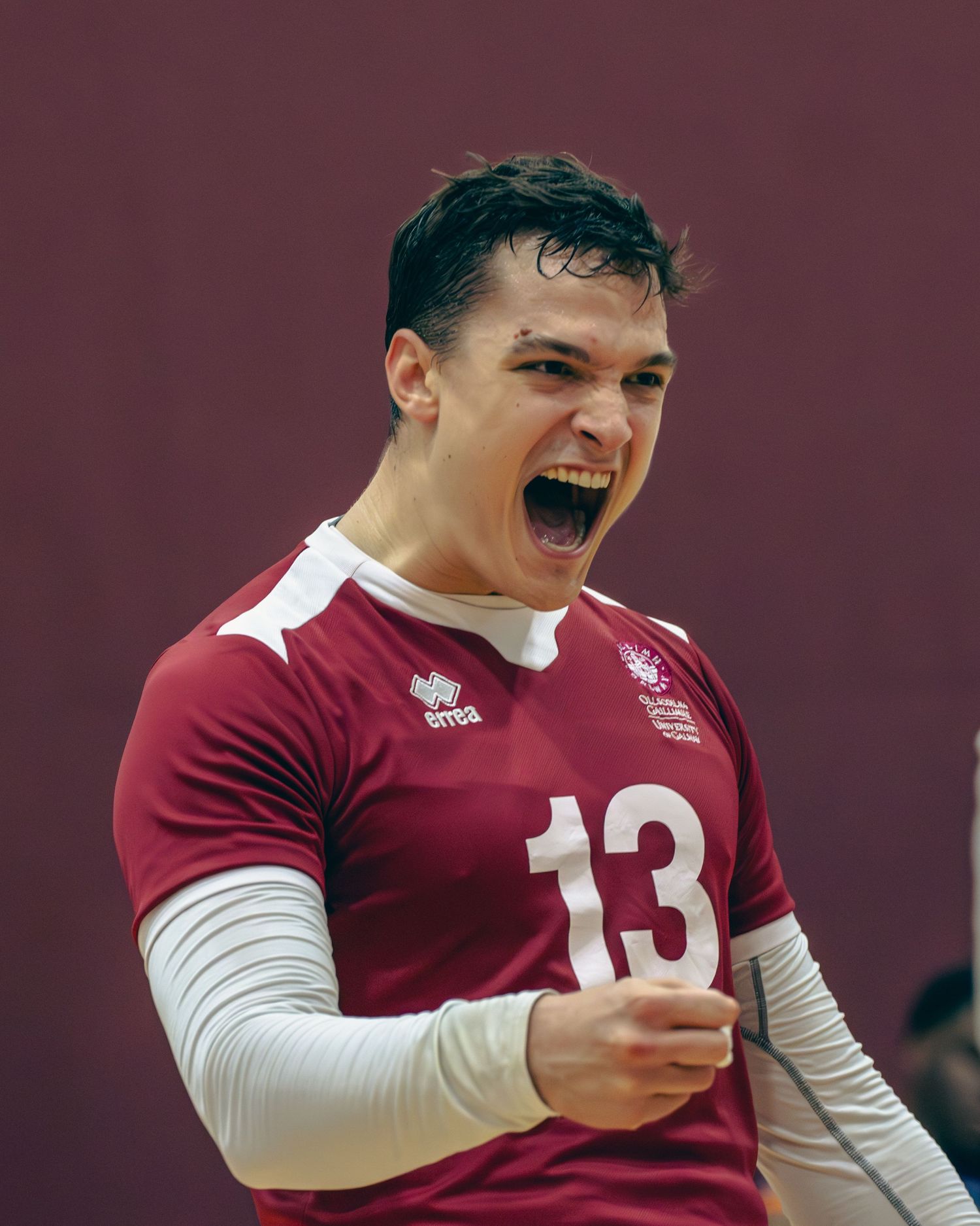 Rugby player in maroon jersey showing intense emotion during competitive match.