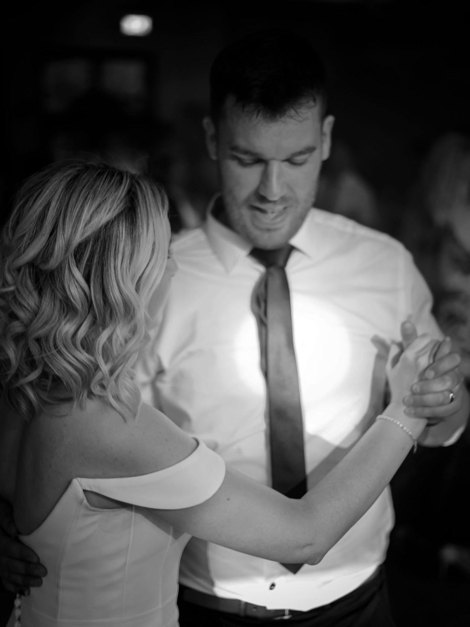 Black and white dance photos showing intimate moments between couples during a romantic slow dance.
