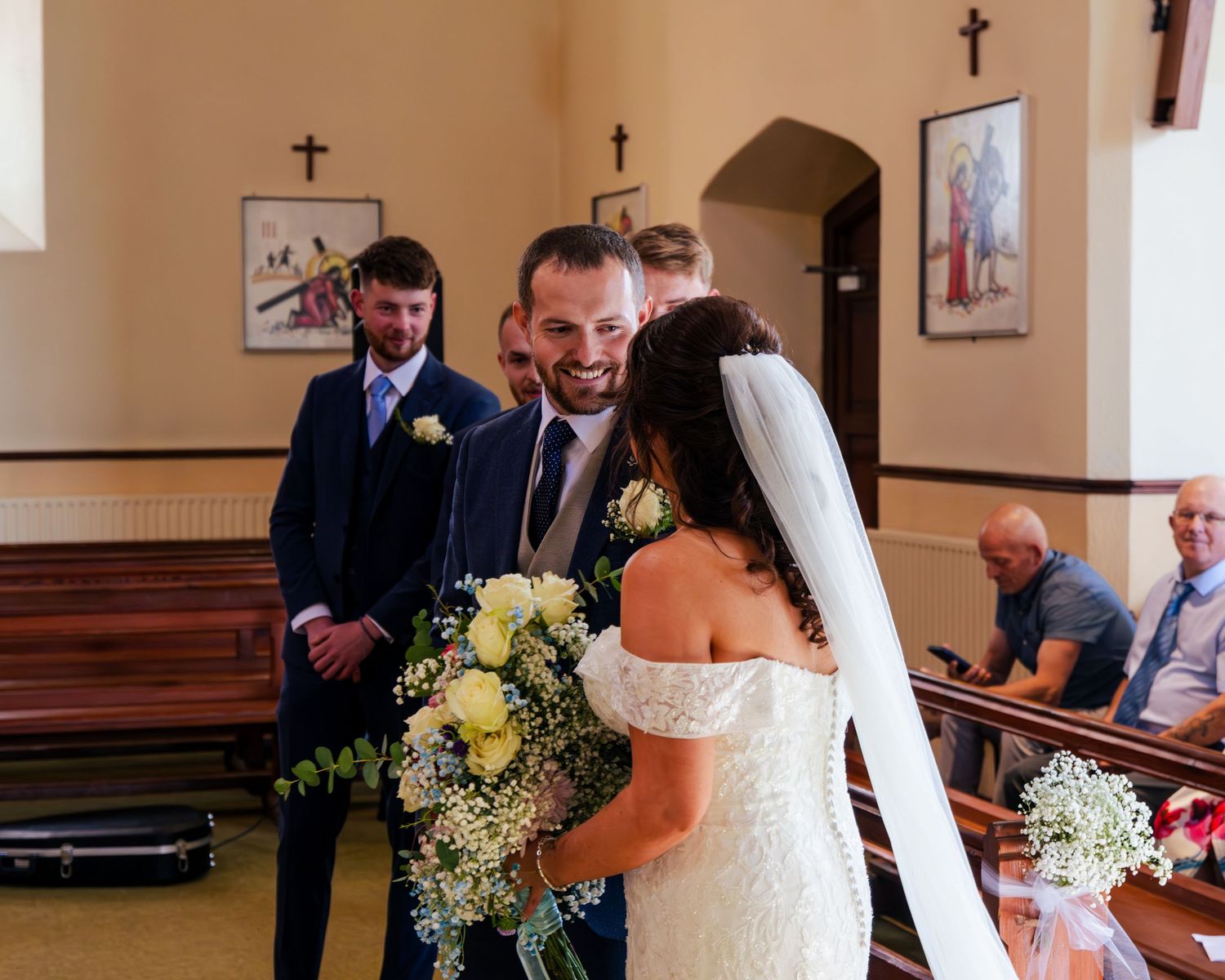 Traditional church wedding ceremony with floral arrangements.