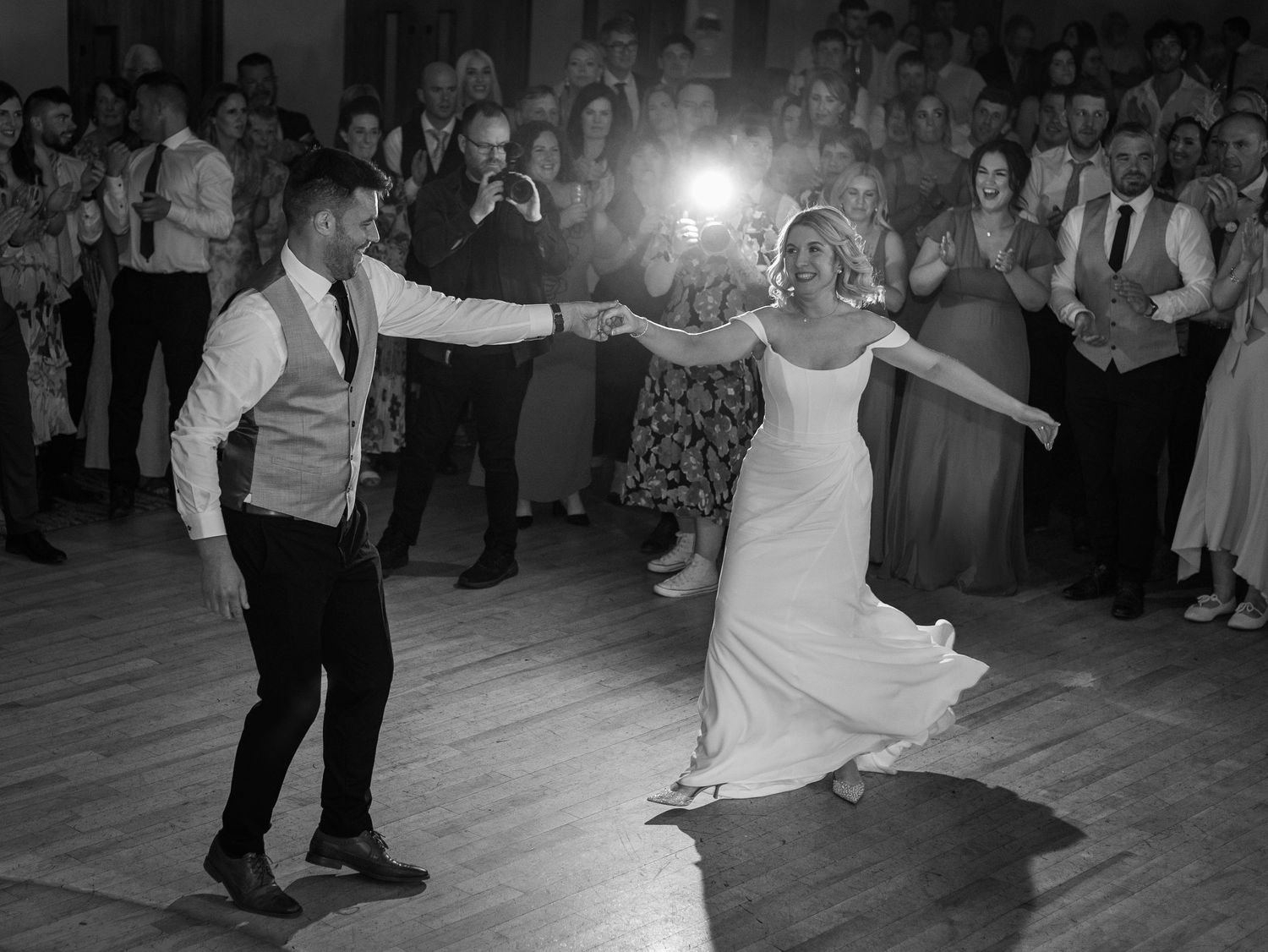 Dynamic dance performance at a wedding reception with dramatic lighting effects.