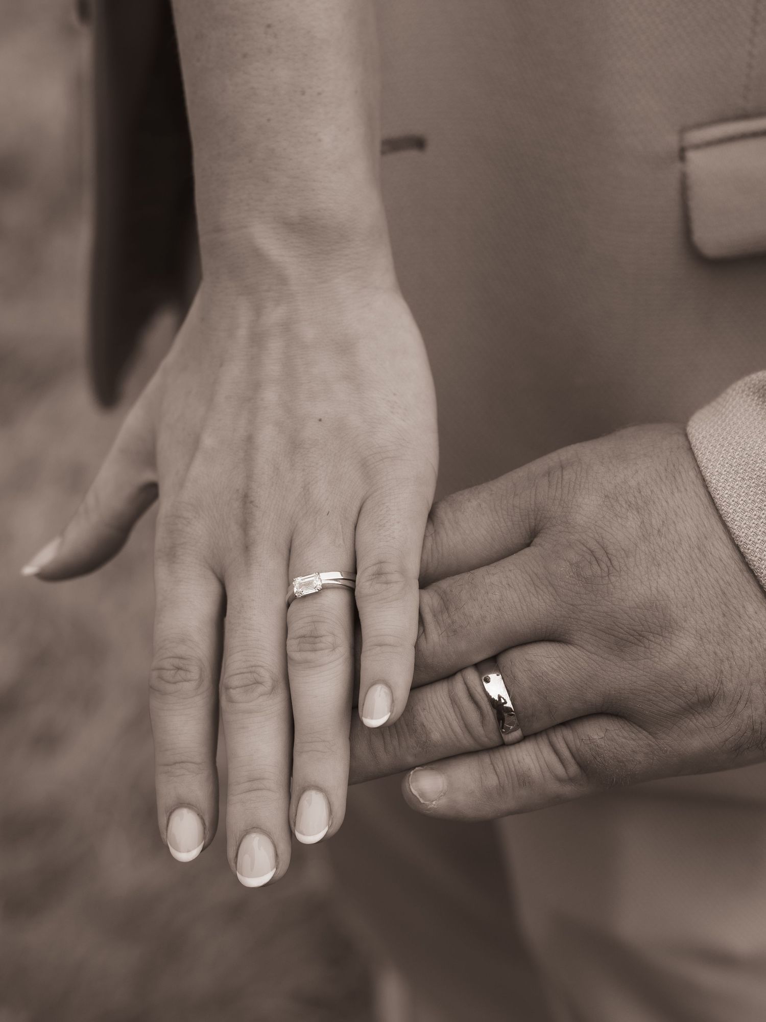 Black and white close-up series showing wedding rings and joined hands with fresh manicure.