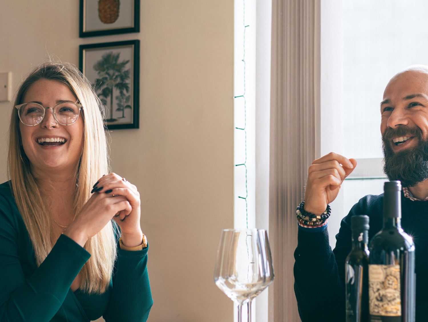 People enjoying chocolate and laughing together in a bright sunlit room.