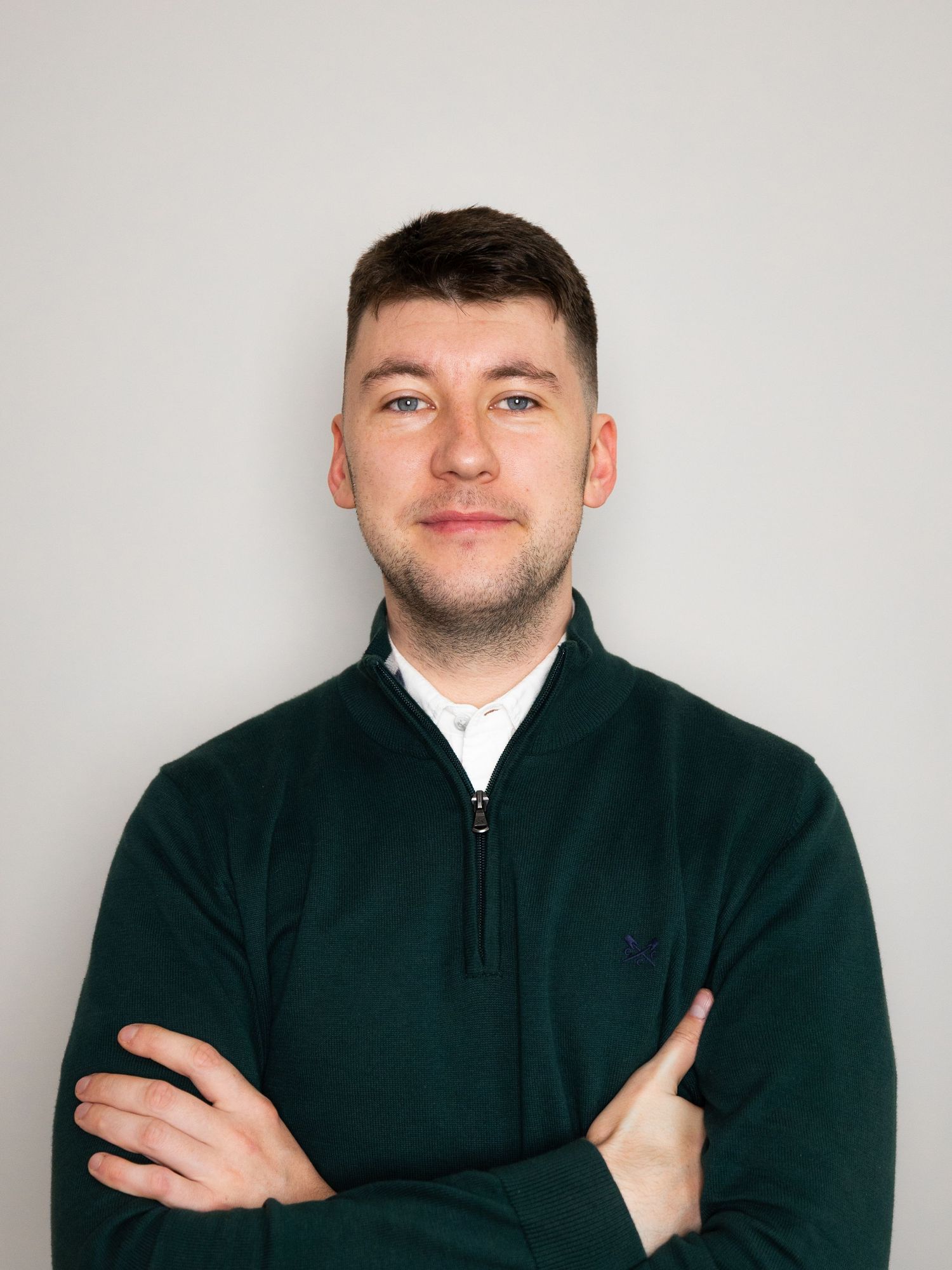Person wearing a dark zip-up jacket shown in four similar poses against a light background.
