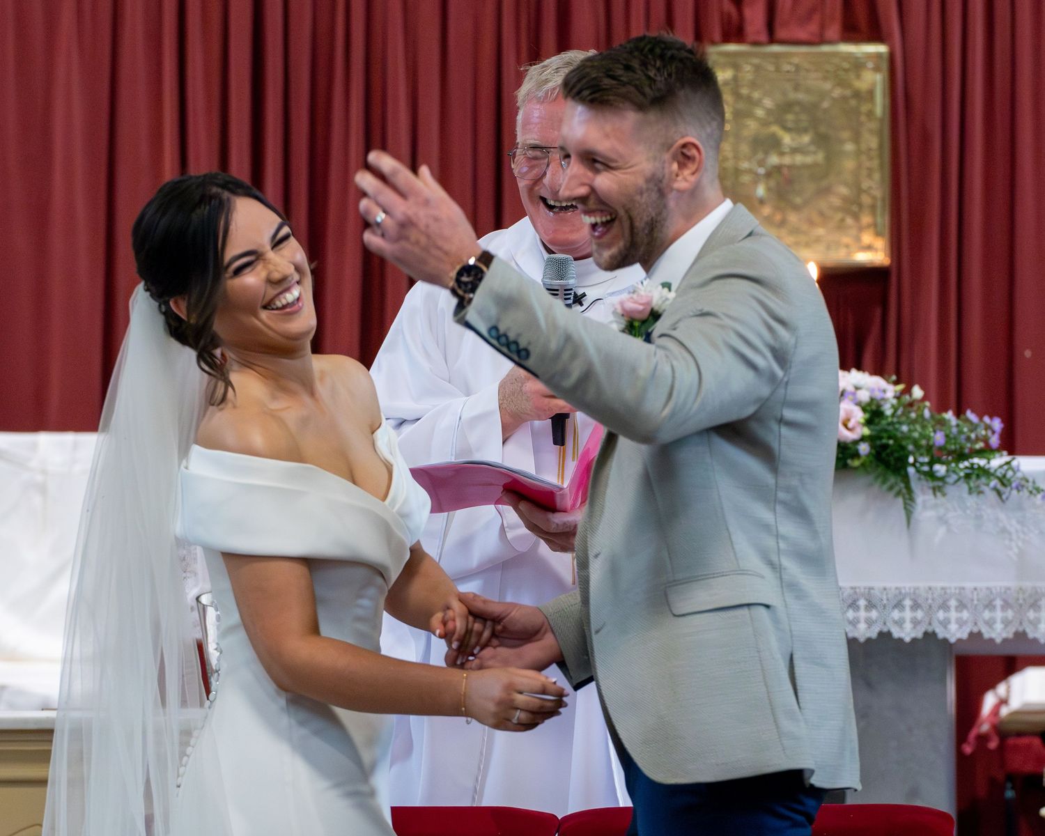 A joyful moment between newlyweds sharing a laugh during their wedding ceremony