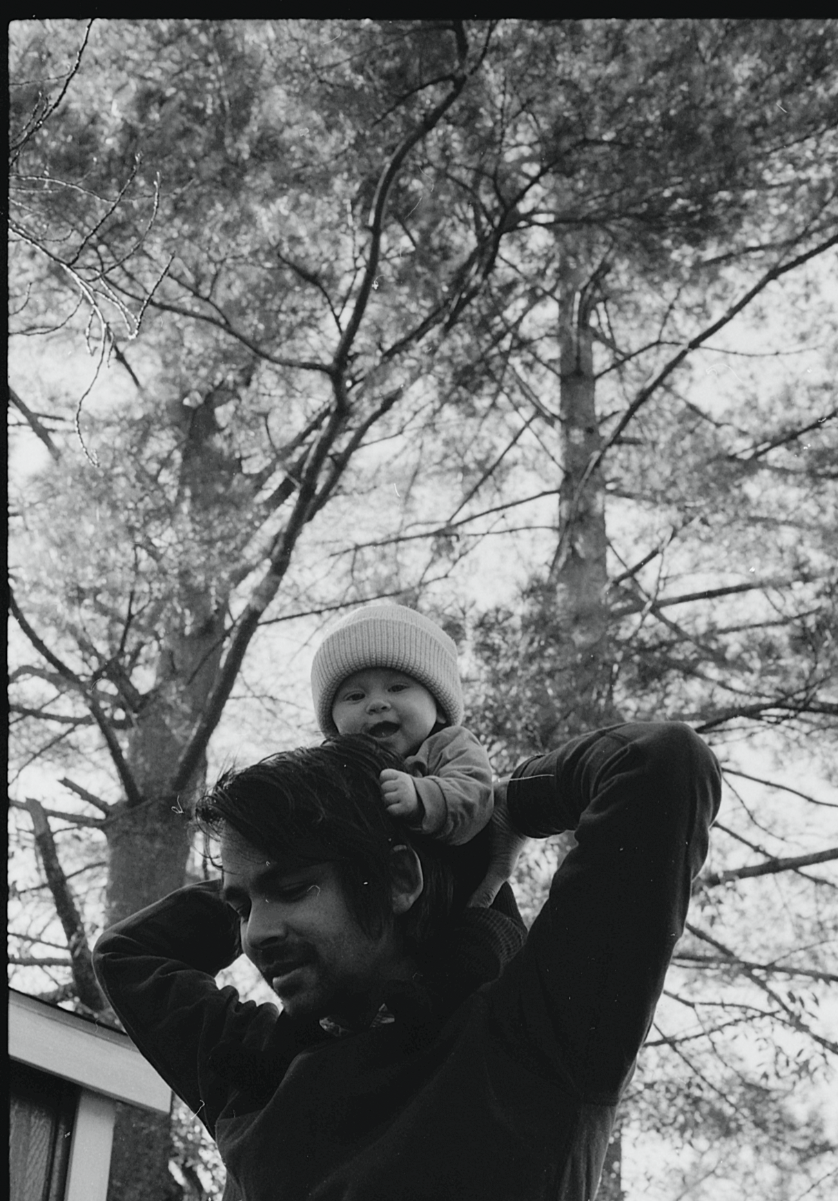 Black and white sequence of playful outdoor moments among trees.