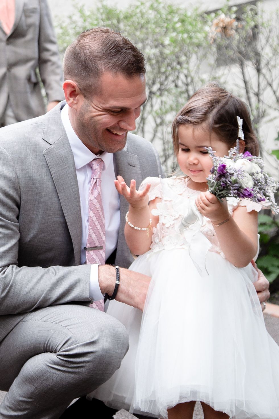 A series of candid moments between a bride in white and groom in gray during their wedding celebrations outdoors.