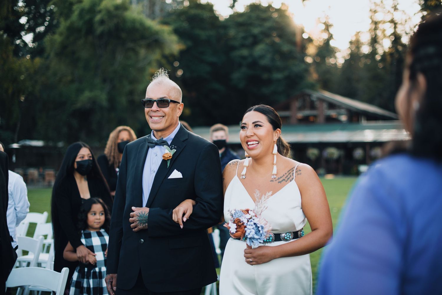 Wedding guests gather outdoors during a sunset ceremony at a scenic venue. Knoxville Wedding Photographer