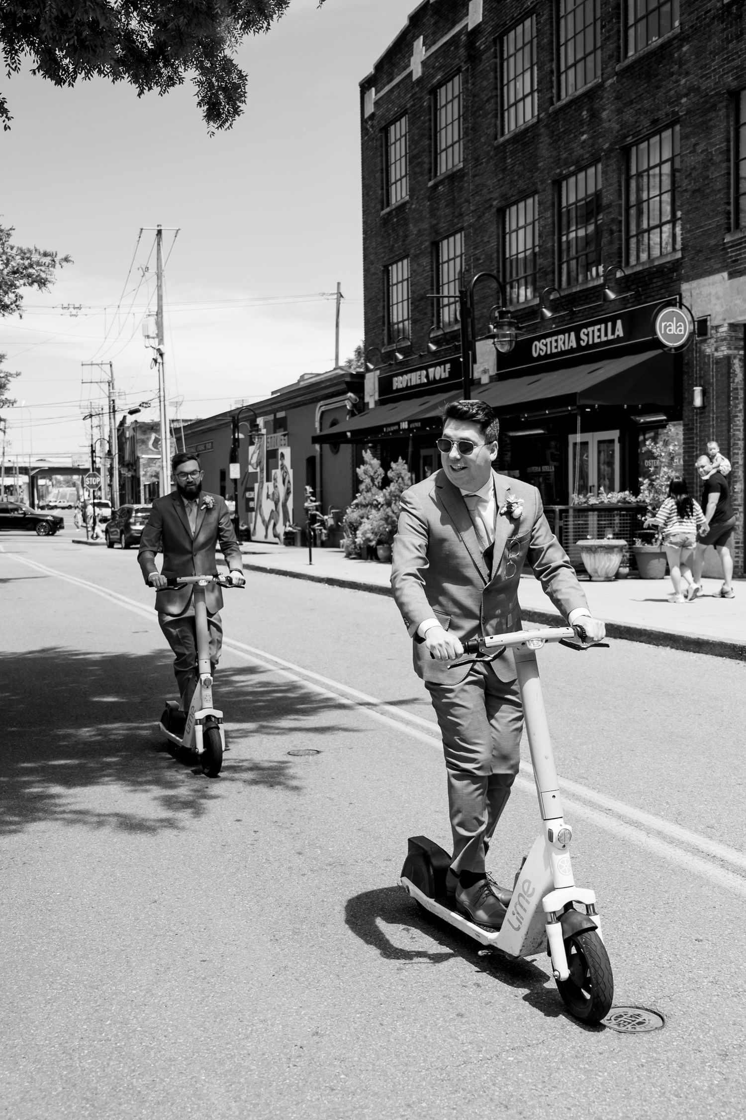 A sequence of black and white photos capturing playful moments on a city street. Knoxville Wedding Photographer