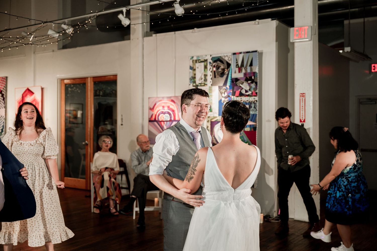Wedding guests dancing and celebrating at an indoor reception venue. Knoxville Wedding Photographer