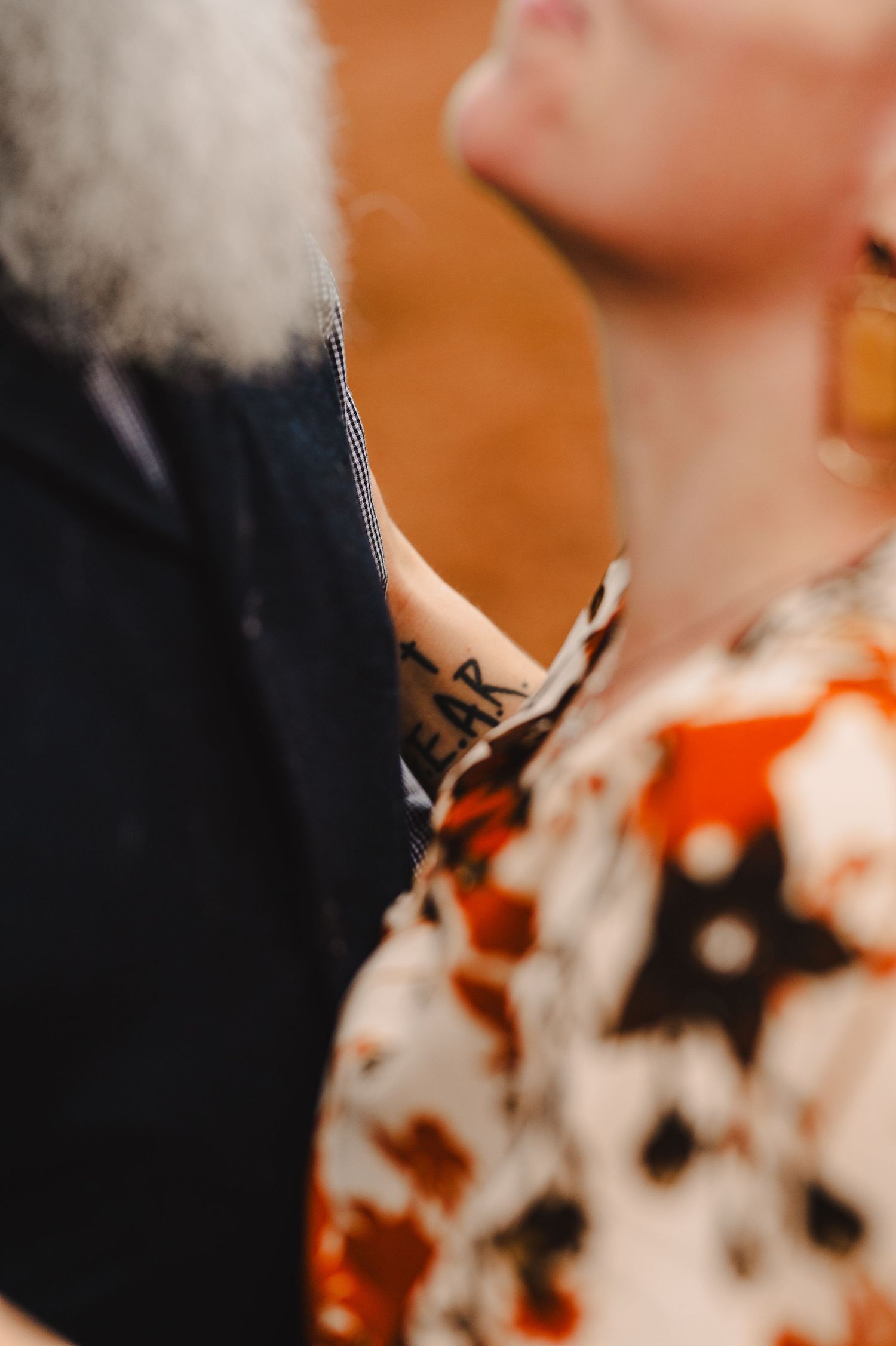 An artistic close-up shot with soft focus and warm orange tones. Knoxville Couple Photographer