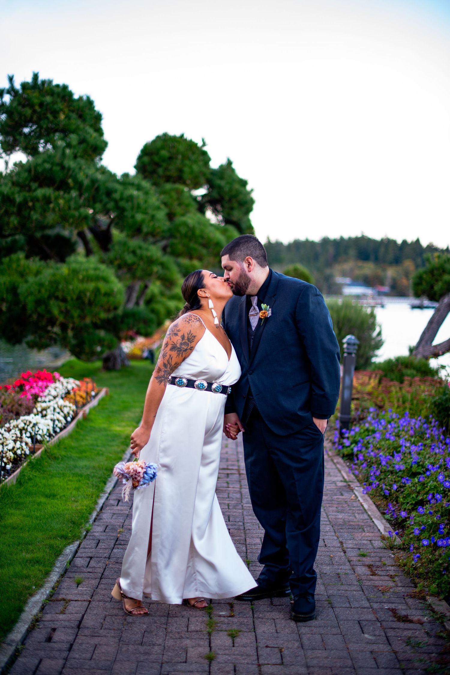 Couple shares romantic moments along a brick pathway with purple flowers. Knoxville Wedding Photographer