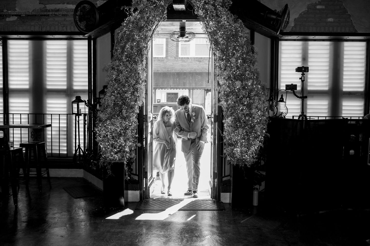 Black and white silhouettes through window frames create dramatic wedding portrait. Knoxville Wedding Photographer. Lola's Industrial Venue